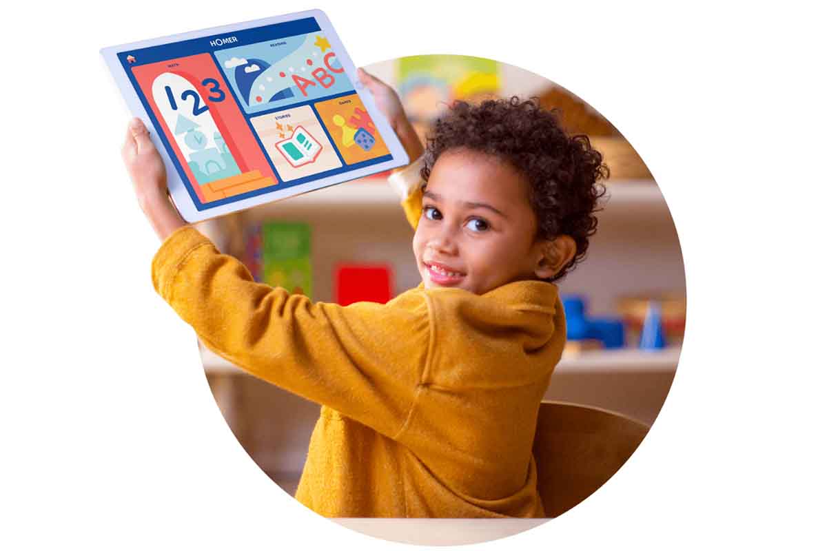 A child holding up a tablet towards the camera and smiling.