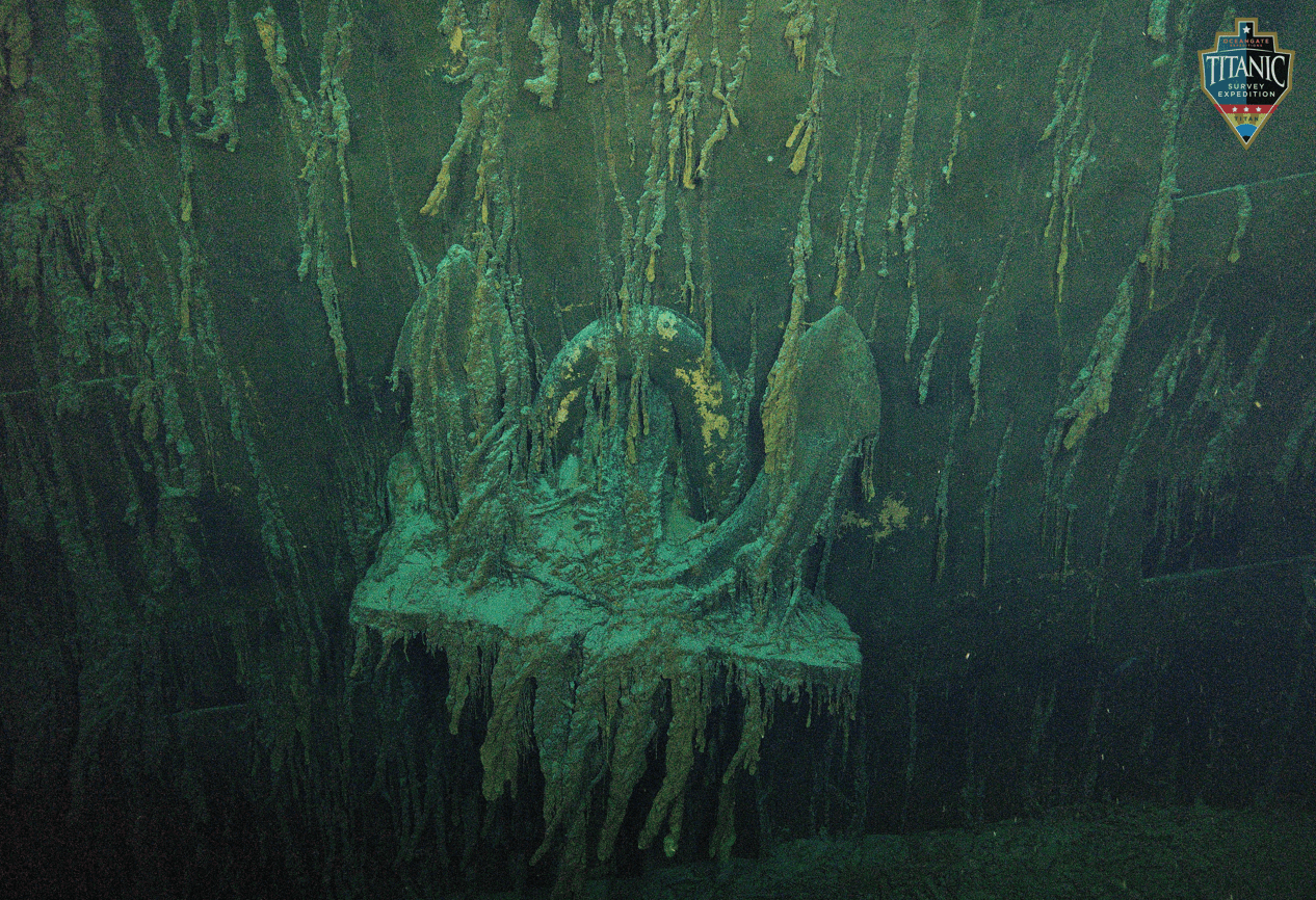 Underwater image showing the anchor of the Titanic covered in seaweed and rust