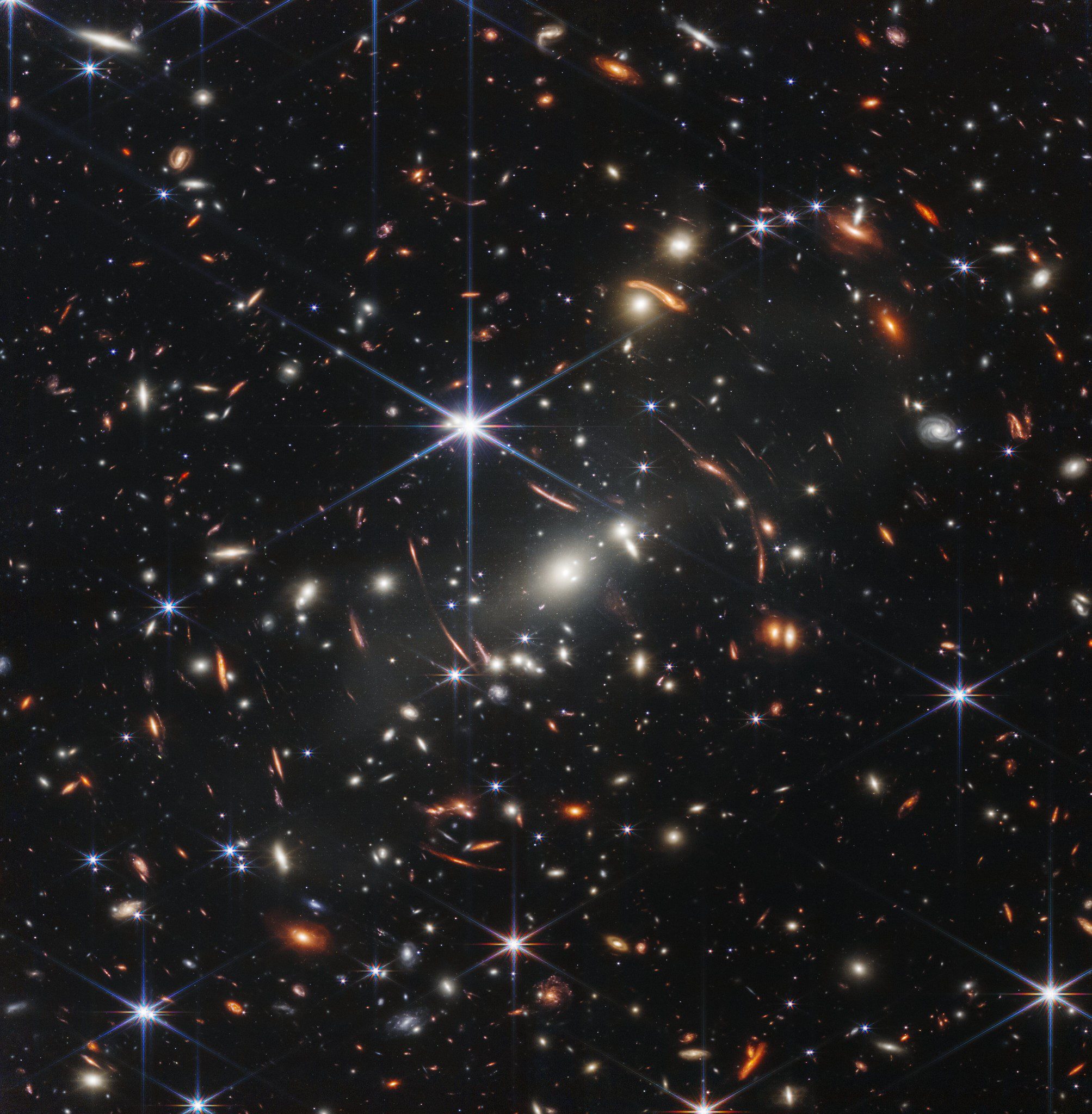 The JWST deep field includes the most distant galaxies we have ever seen, amplified by a powerful gravitational lens. Some of the galaxies are so distant they challenge standard cosmology. Image credit: NASA, ESA, CSA, and STScI