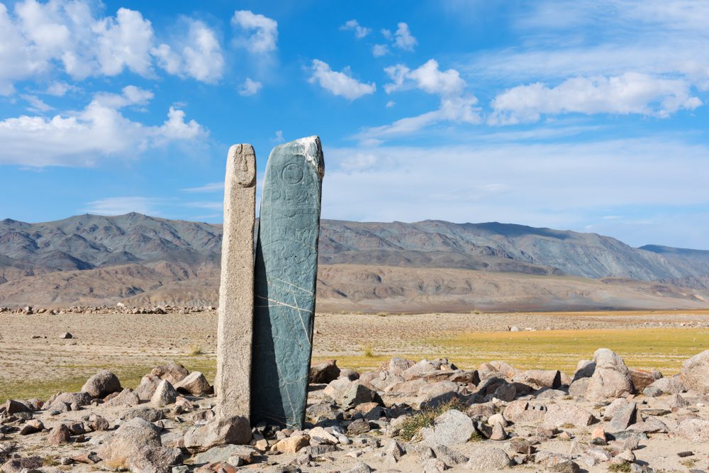 Mongolia steppe landscape. Deer stone Tsjagaan-Go is a famous ancient monument situated nearby of Hovd river.