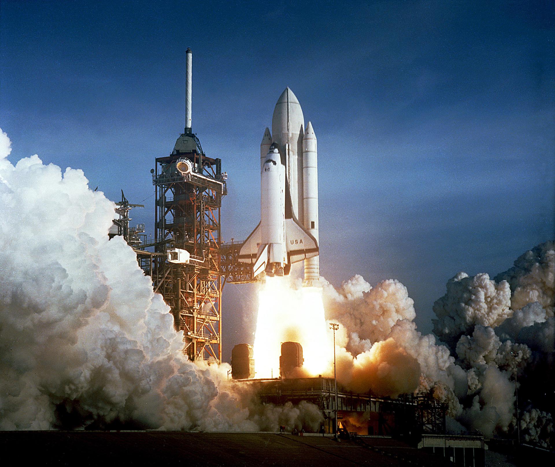 The image show first ever space shuttle launch as columbia is about to fly beyond the tower. The booster and the tank are all white, instead of the tank being orange.