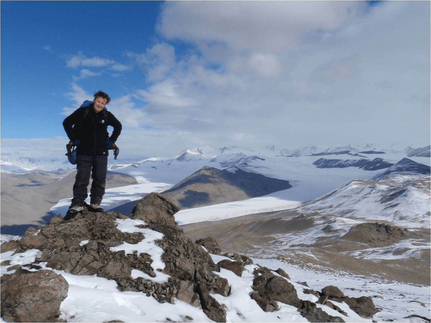  Dr Mark Stevens standing on a nunatak (rocky outcrop) overlooking Miers Valley, Antarctica