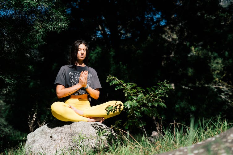 Woman sitting in meditation pose.