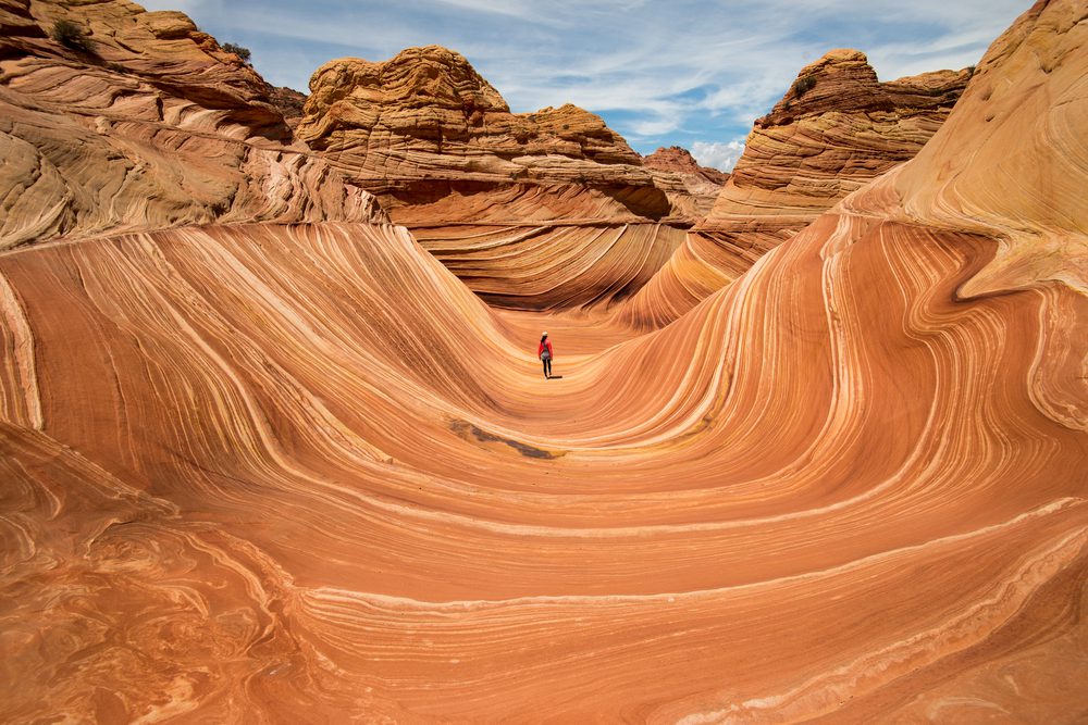 The Wave of Arizona swirling red sandstone goelogy with a human for scale. 