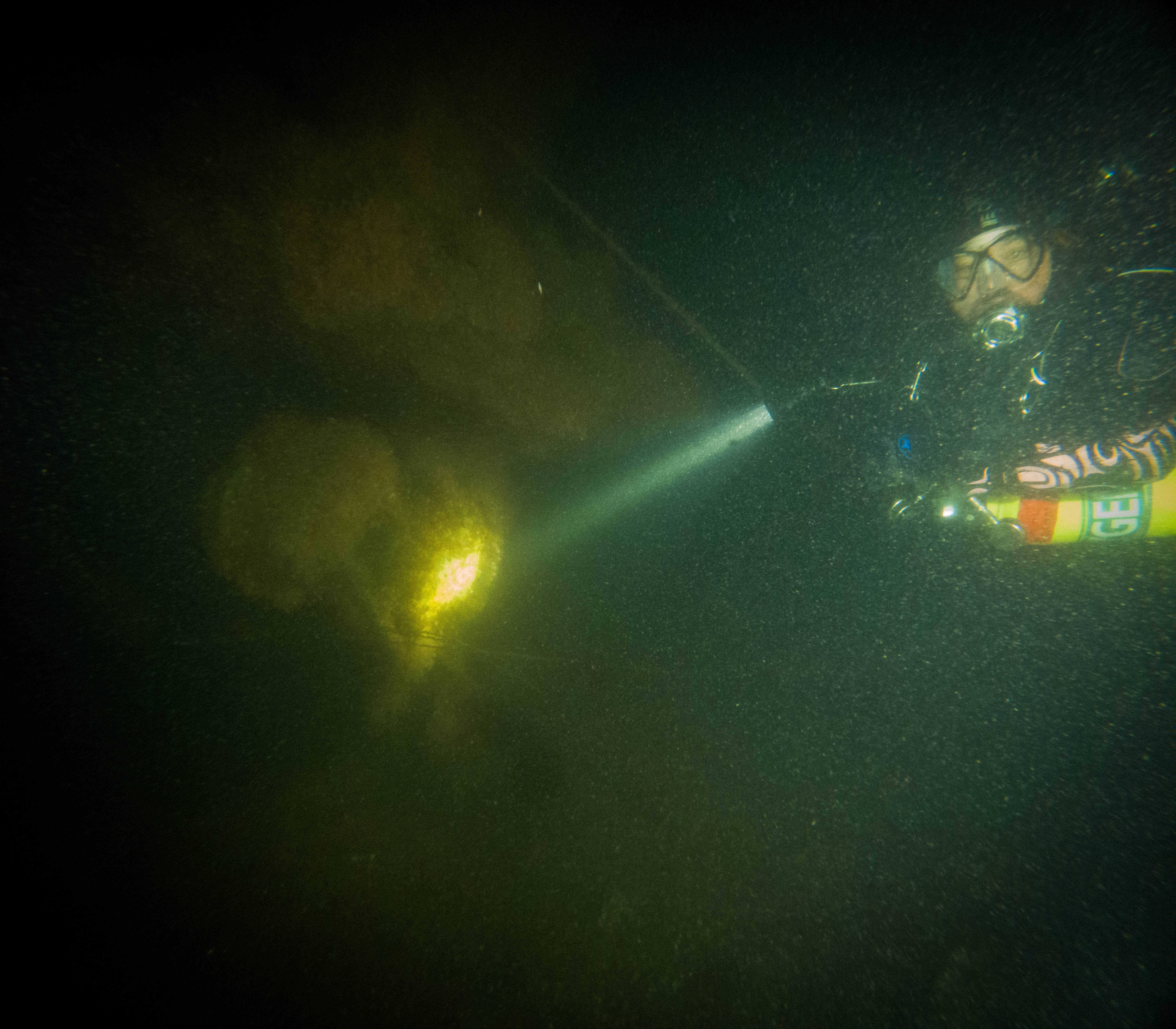 Diver Steve Abbate inspects one of submarine Defender’s propellers underwater.
