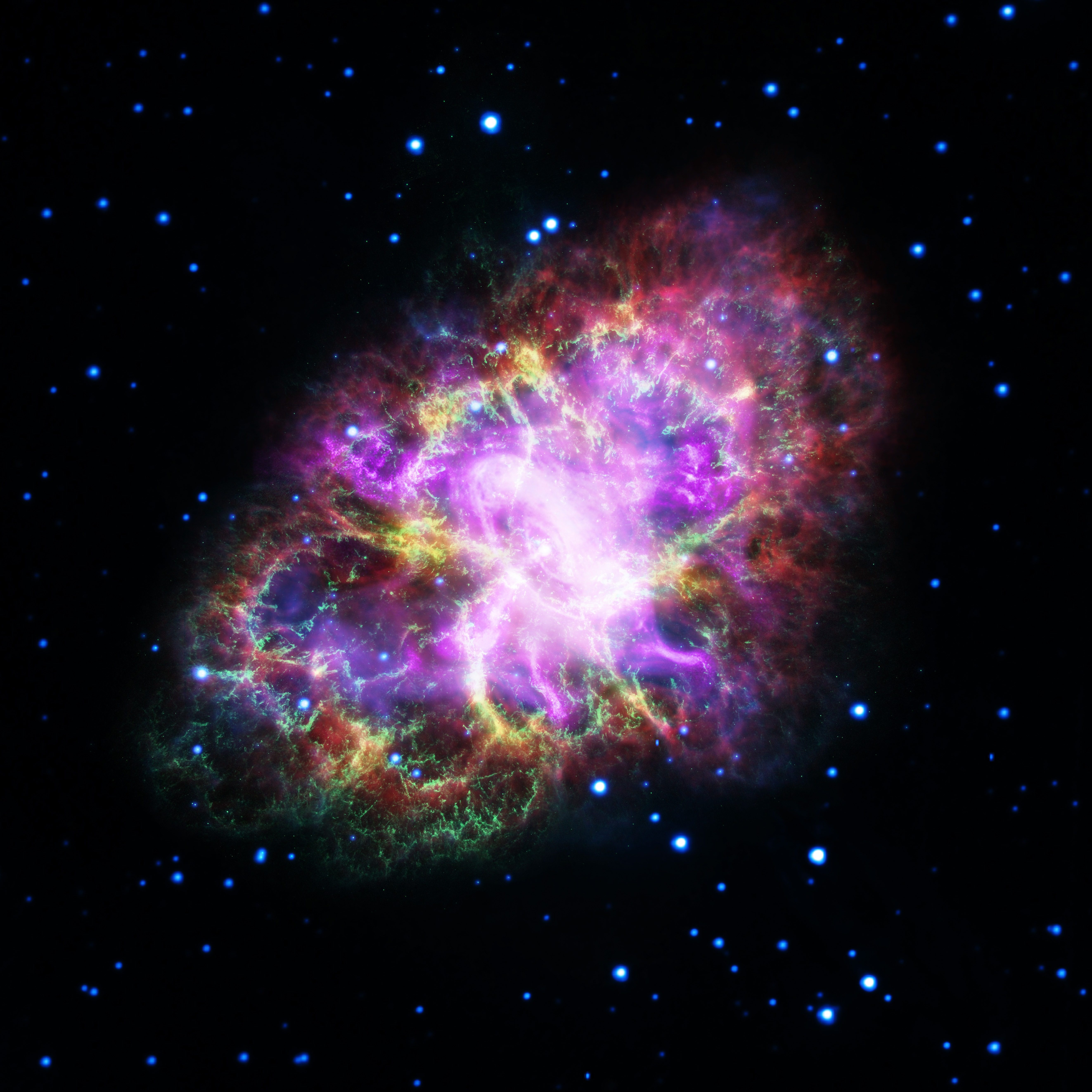 Image of the Crab Nebula where red is radio from the Very Large Array, yellow is infra-red from the Spitzer Space Telescope, green is visible from the Hubble Space Telescope, and blue and purple are X-ray from the XMM-Newton and Chandra X-ray Observatories respectively. Image credit: NASA, ESA, G. Dubner (IAFE, CONICET-University of Buenos Aires) et al.; A. Loll et al.; T. Temim et al.; F. Seward et al.; VLA/NRAO/AUI/NSF; Chandra/CXC; Spitzer/JPL-Caltech; XMM-Newton/ESA; and Hubble/STScI