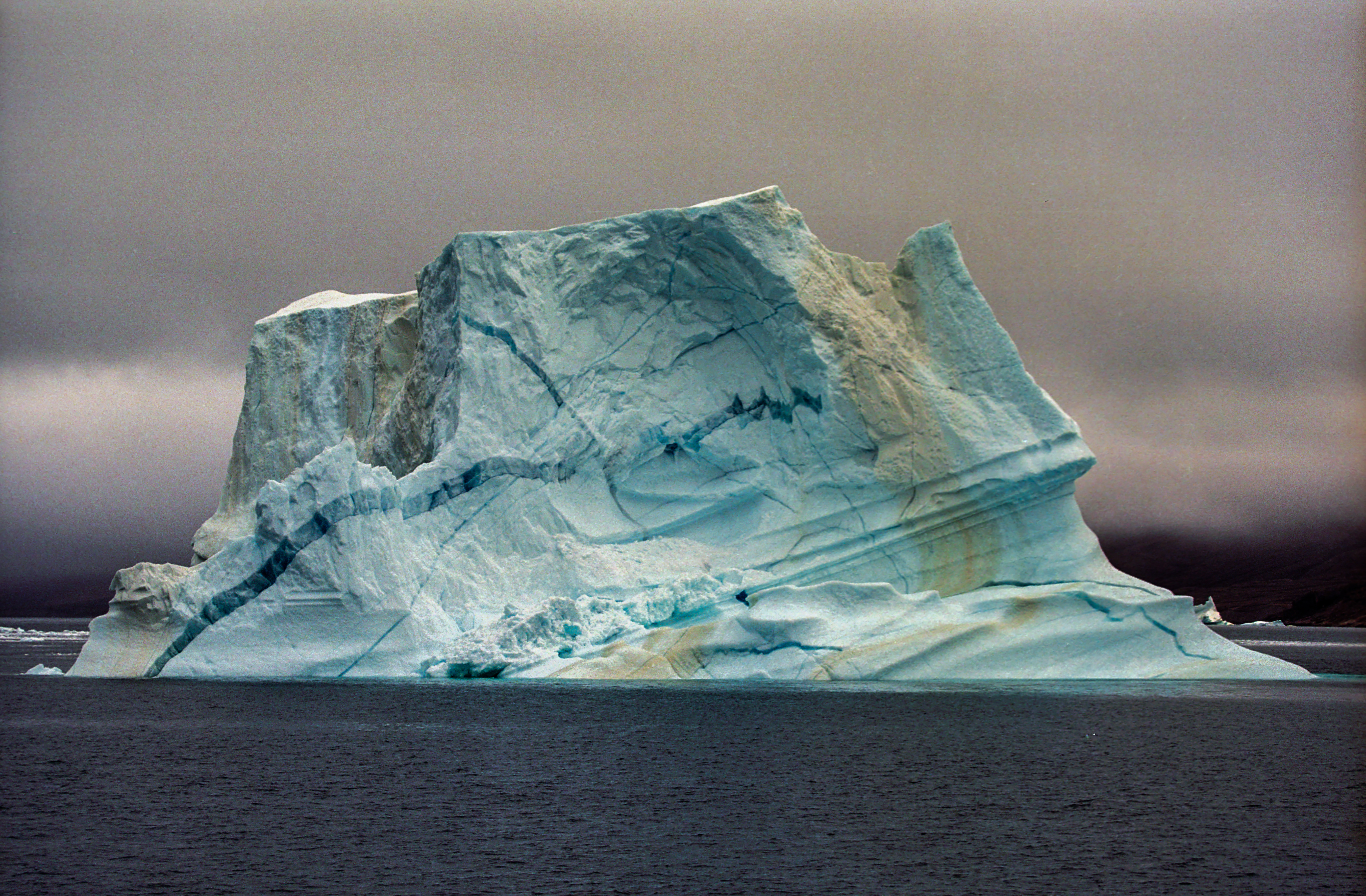 Yellow and blue stripes within a white iceberg