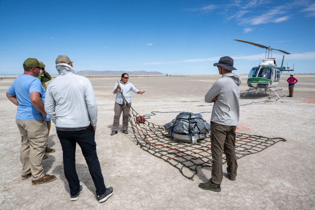 OSIRIS-REx team members practice getting a mock sample capsule packed for its helicopter flight to a clean room on the Department of Defense’s Utah Test and Training Range. On July 18-20, 2023, the team rehearsed retrieving a mock sample capsule at the location where the real one, with samples of asteroid Bennu, will land on Sept. 24