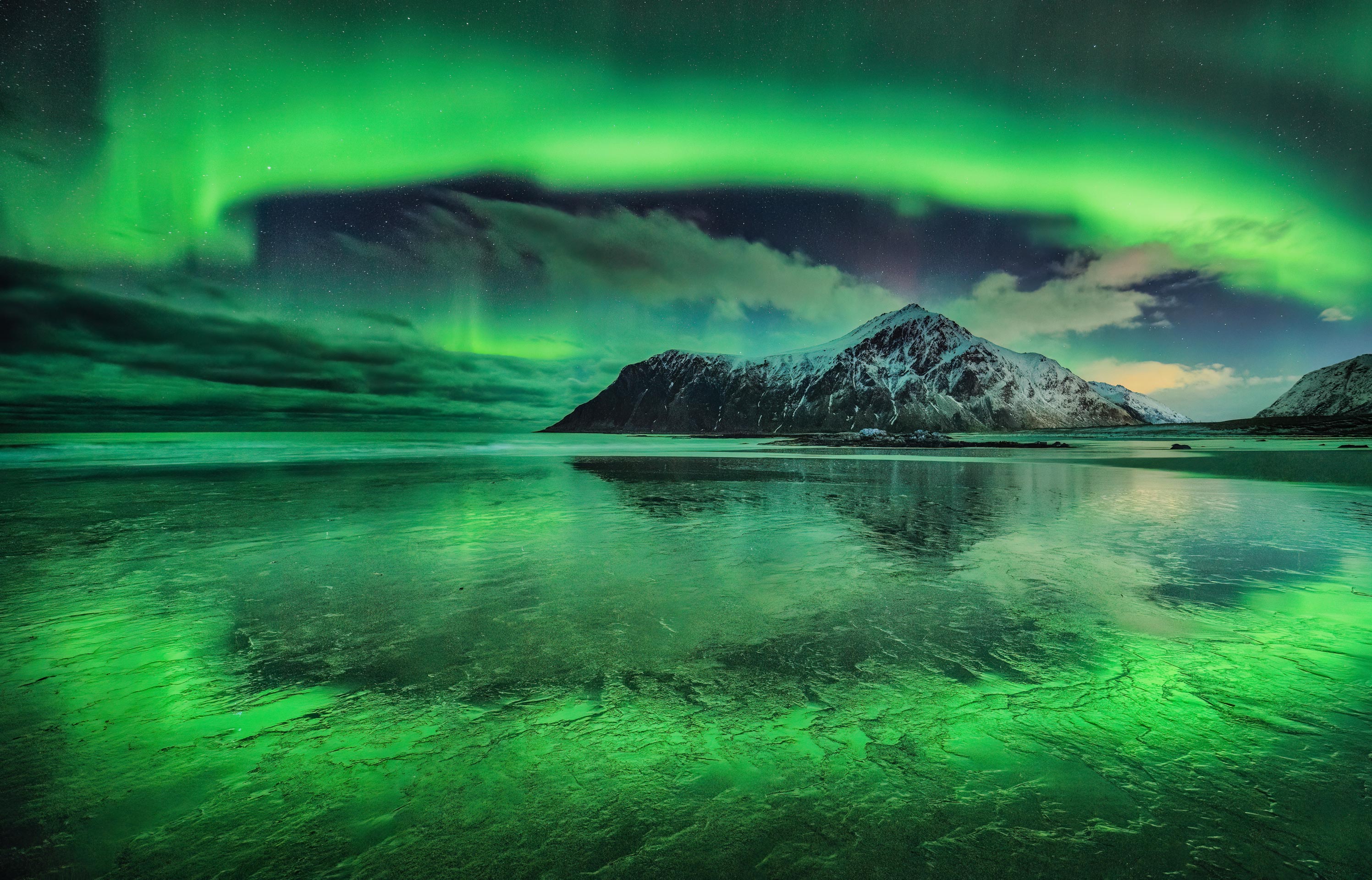 Circle of green aurora around a mountain