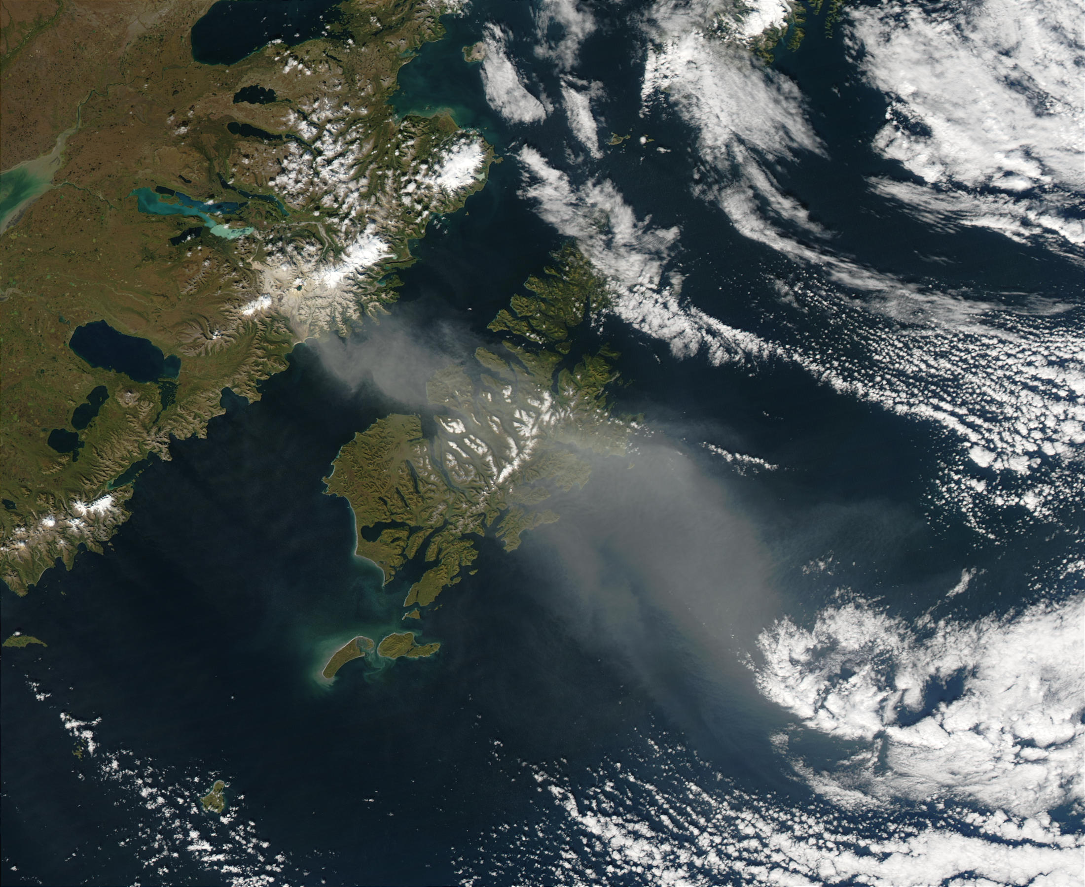 A true-color image of resuspended volcanic ash looming over Kodiak Island, Alaska,