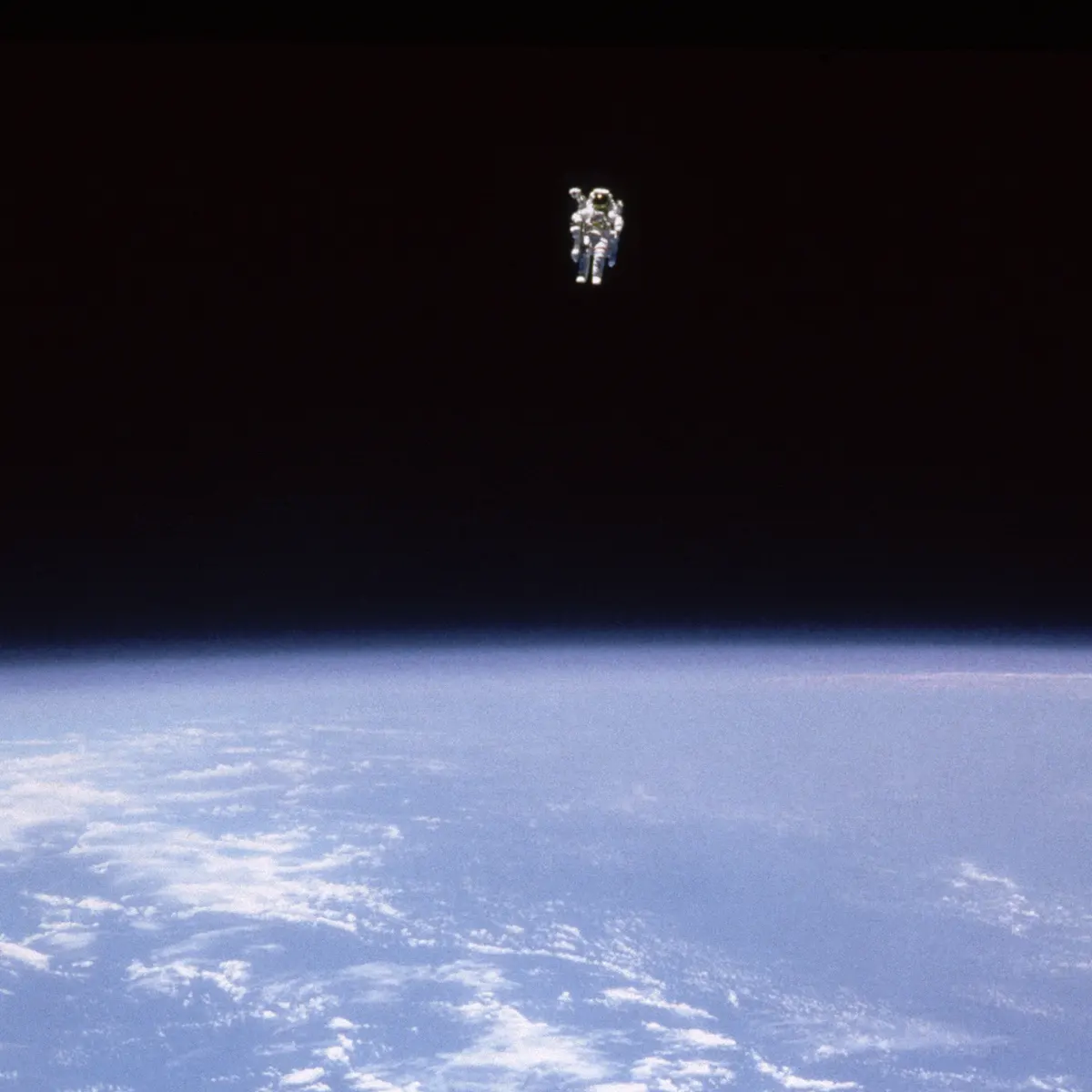 Astronaut Bruce McCandless II floating untethered in space.