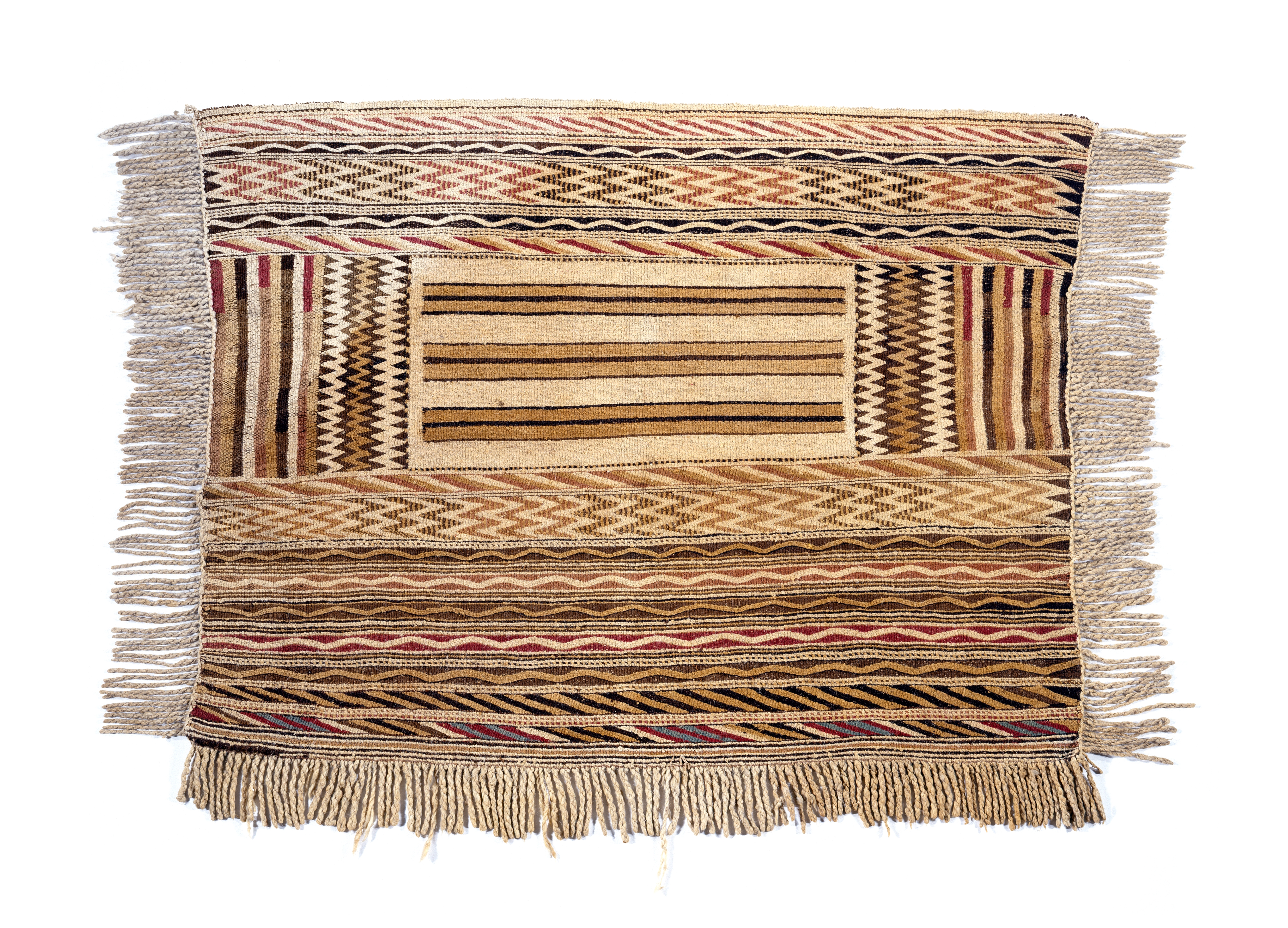 Traditional woven Coast Salish blanket with tassels and geometric patterns of zigzags and lines in shades of beige, brown and red Traditional woven Coast Salish blanket with tassels and geometric patterns of zigzags and lines in shades of beige, brown and red