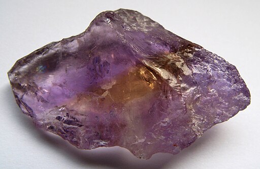 A lump of ametrine - a mostly-purple quartz with a visible line of yellow through the center