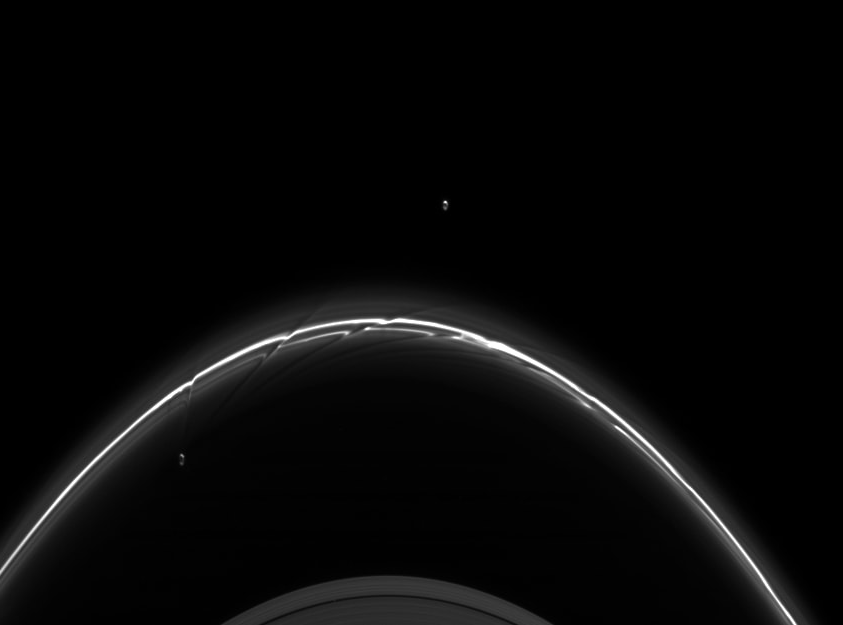 The moons Pandora and Prometheus and Saturn's F ring. These two moons, around 80km wide, keep the F ring, which would otherwise be too far out to survive, in line. It was thought something similar was happening with Chariklo, but only one moon may be required.