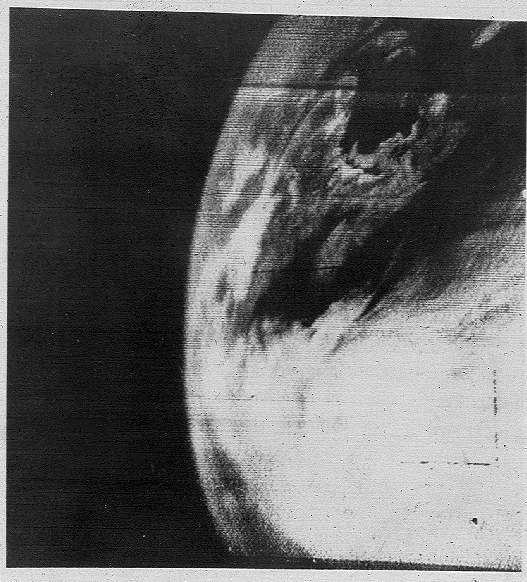 A black and white image of Earth showing some clouds.