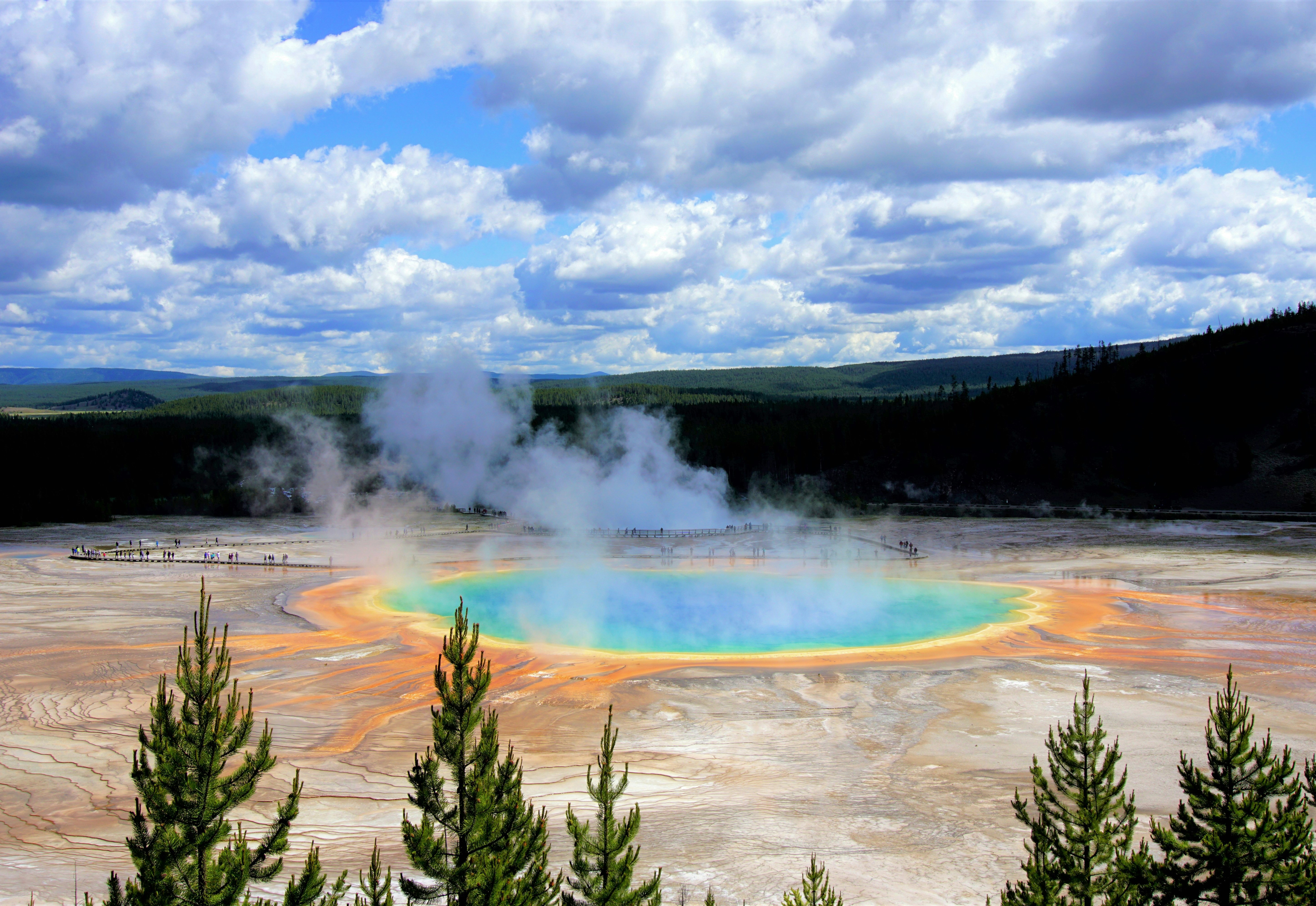 Steam come sout of A rainbow-colored geothermal hotspring at the Yellowstone National Park.