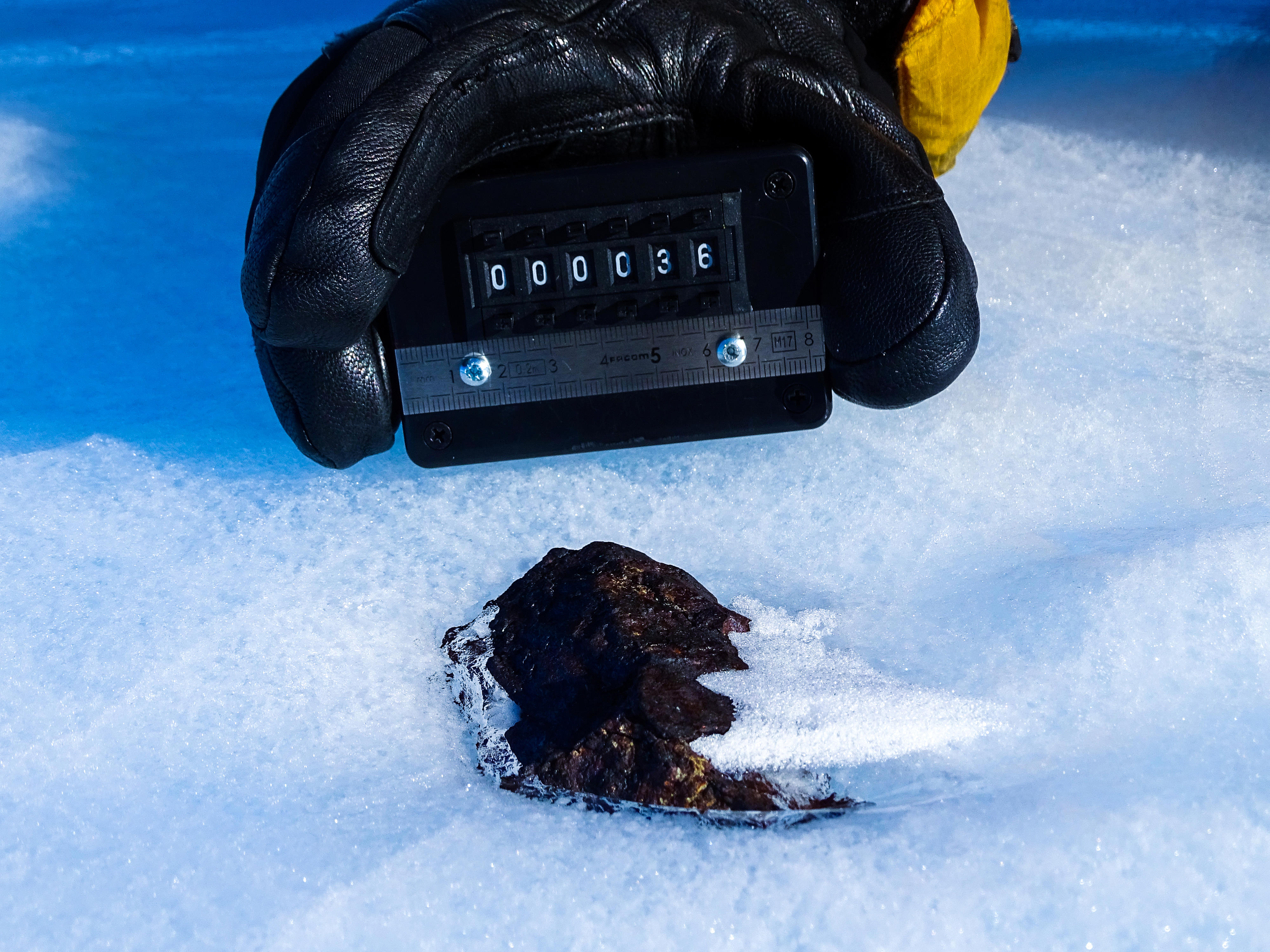 Antarctic meteorite (HUT 18036) partially in the ice, in contrast to most samples that are collected while lying on the surface. 