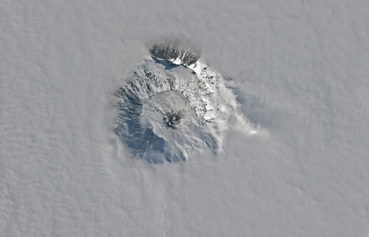 A satellite image of Mount Erebus breaking through the clouds of Antarctica on November 25, 2023