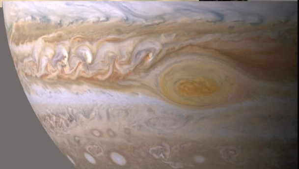 A photo of the jovian atmosphere shwoign crescnet like clouds