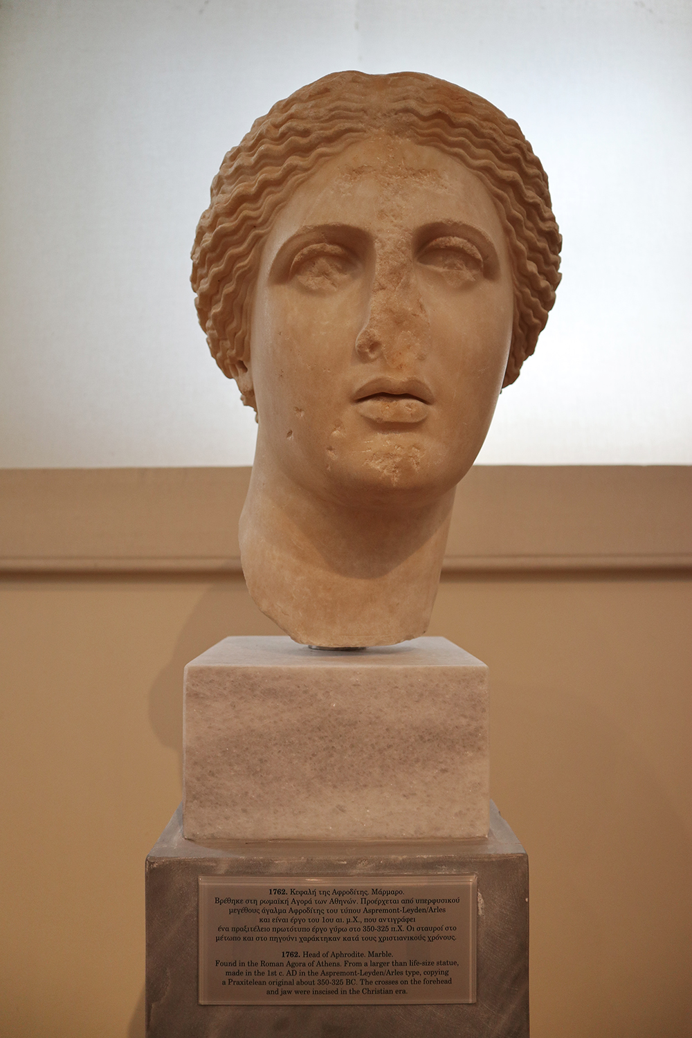 marble statue depicting the head of Aphrodite, missing its nose