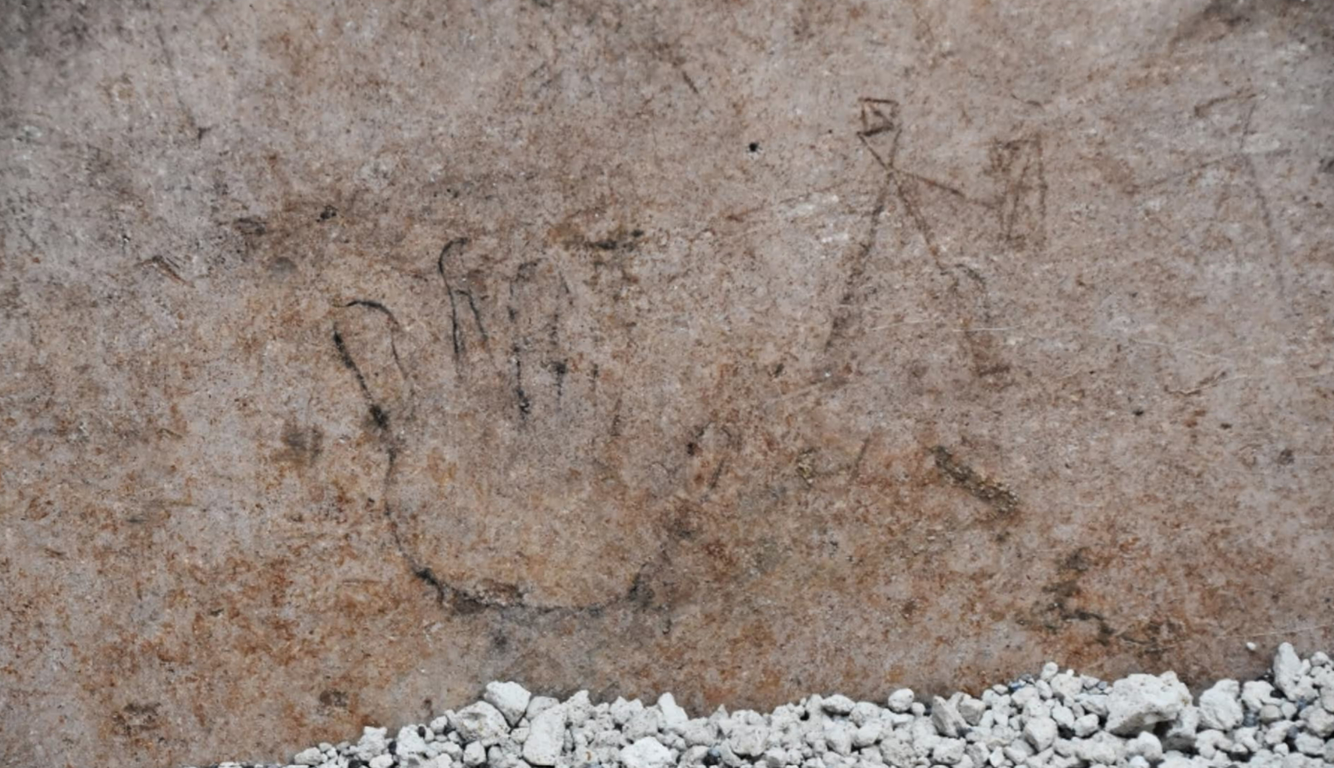 The outline of a small hand, perhaps of a child, found among the ancient graffiti in Pompeii