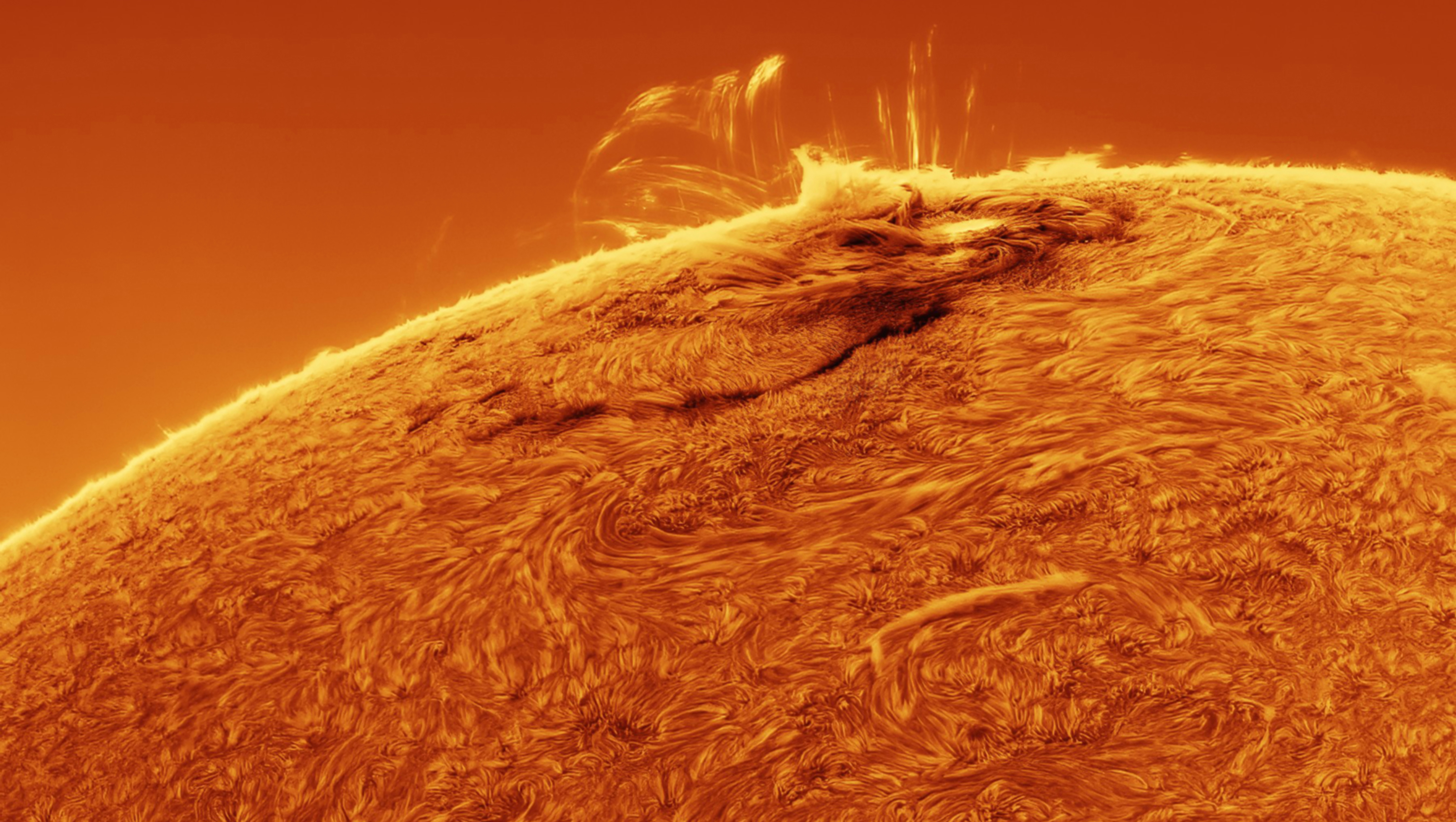 The limb of the sun is visible with eruption coming from it. 