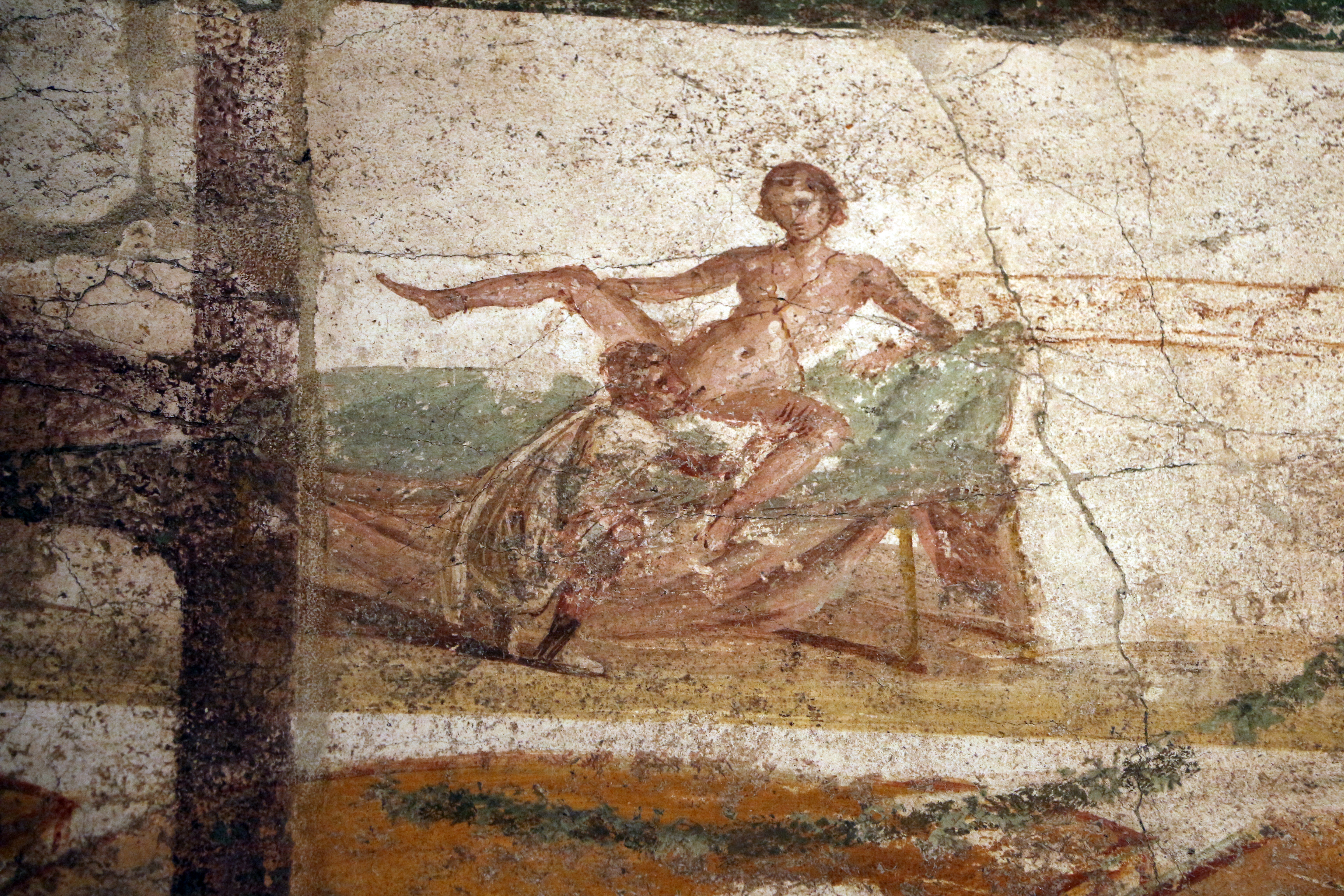 A fresco showing a Roman man squatting on the floor by a bed as he performs oral sex on a woman who is splayed out on the bed. She is holding her right leg up while he is pressing against her left. A fresco showing a Roman man squatting on the floor by a bed as he performs oral sex on a woman who is splayed out on the bed. She is holding her right leg up while he is pressing against her left.