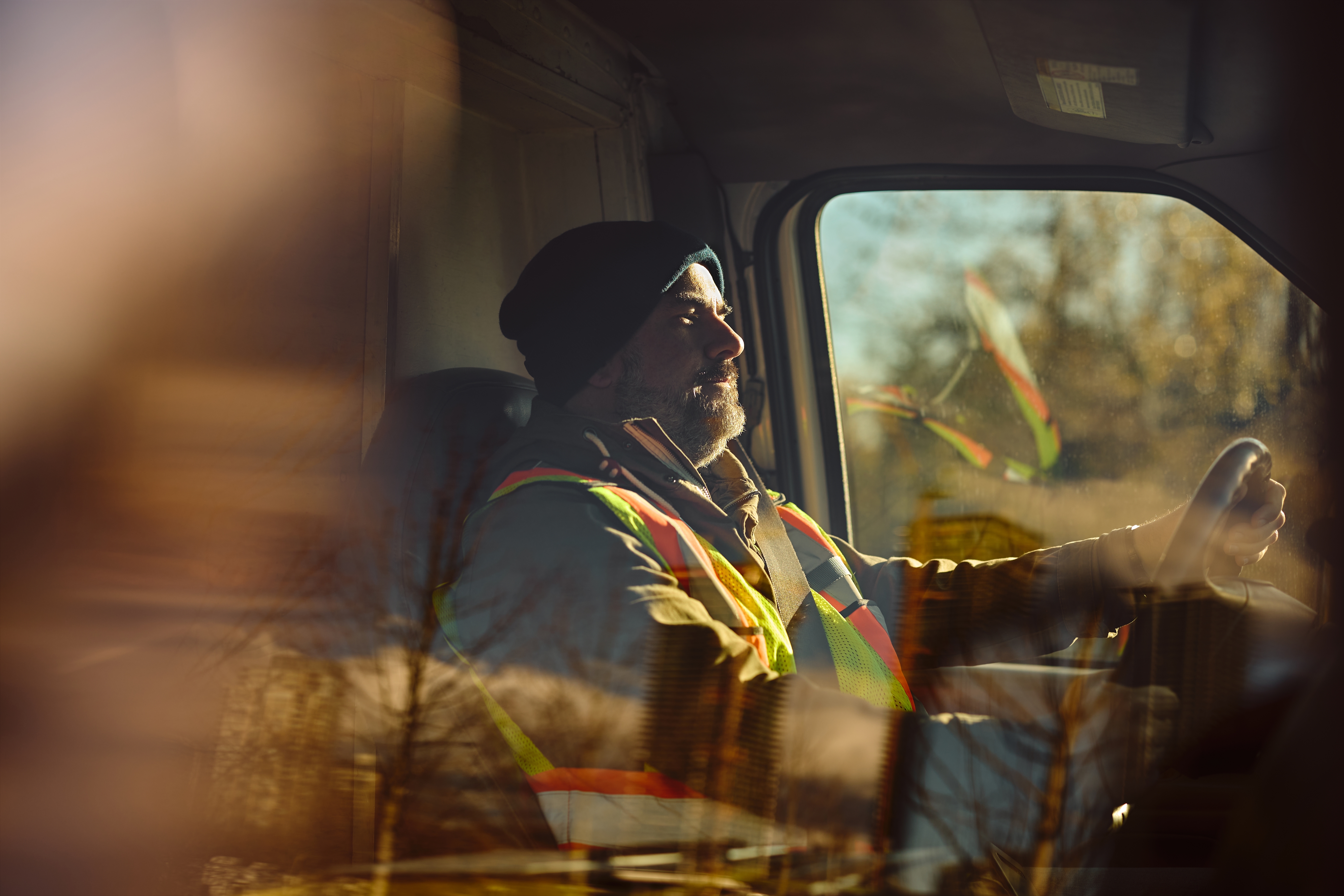 Male driver behind the steering wheel of a truck