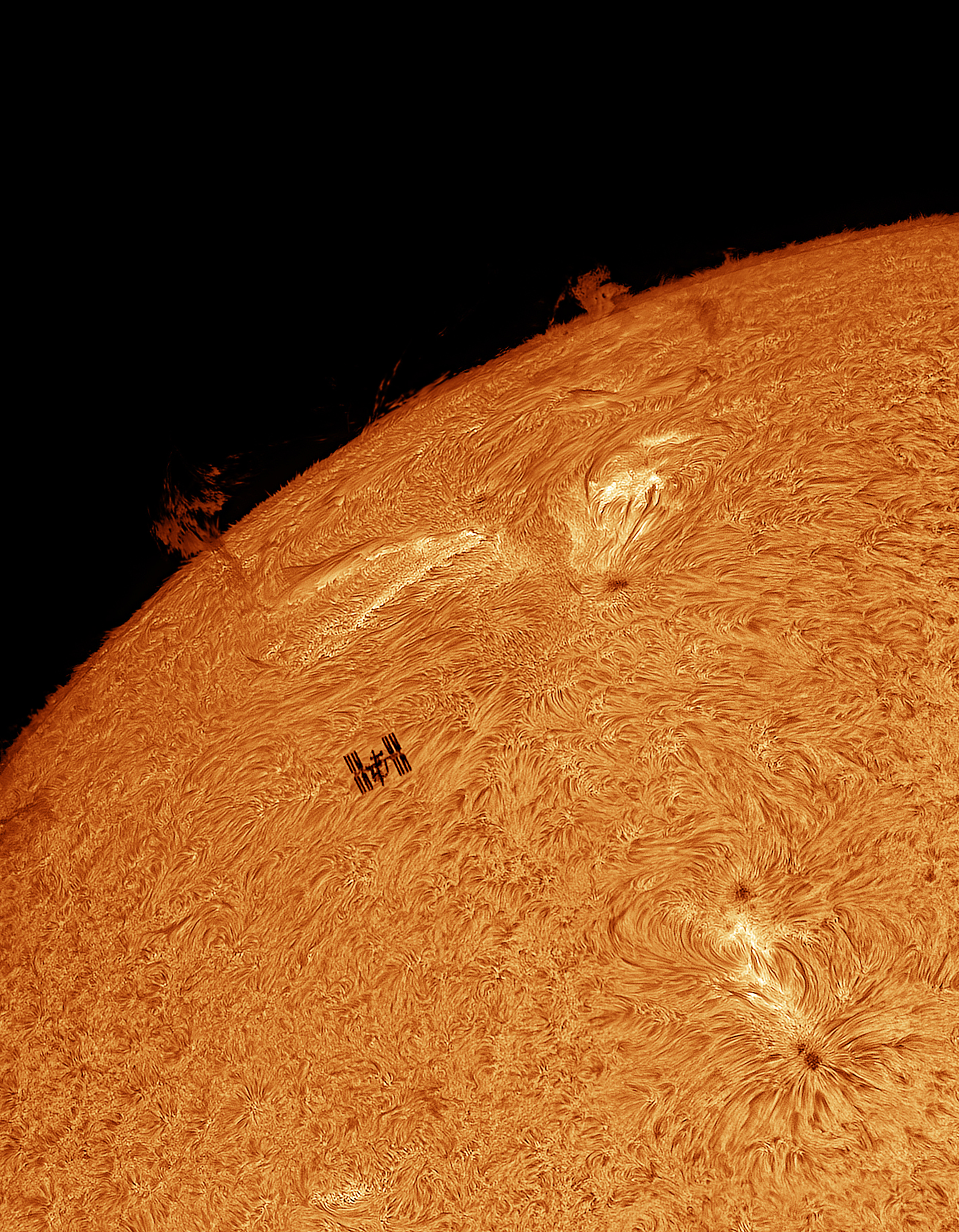 the surface of the sun looks like a field of wheat, thin bright strands moving about. Across it the ISS is clearly visible 