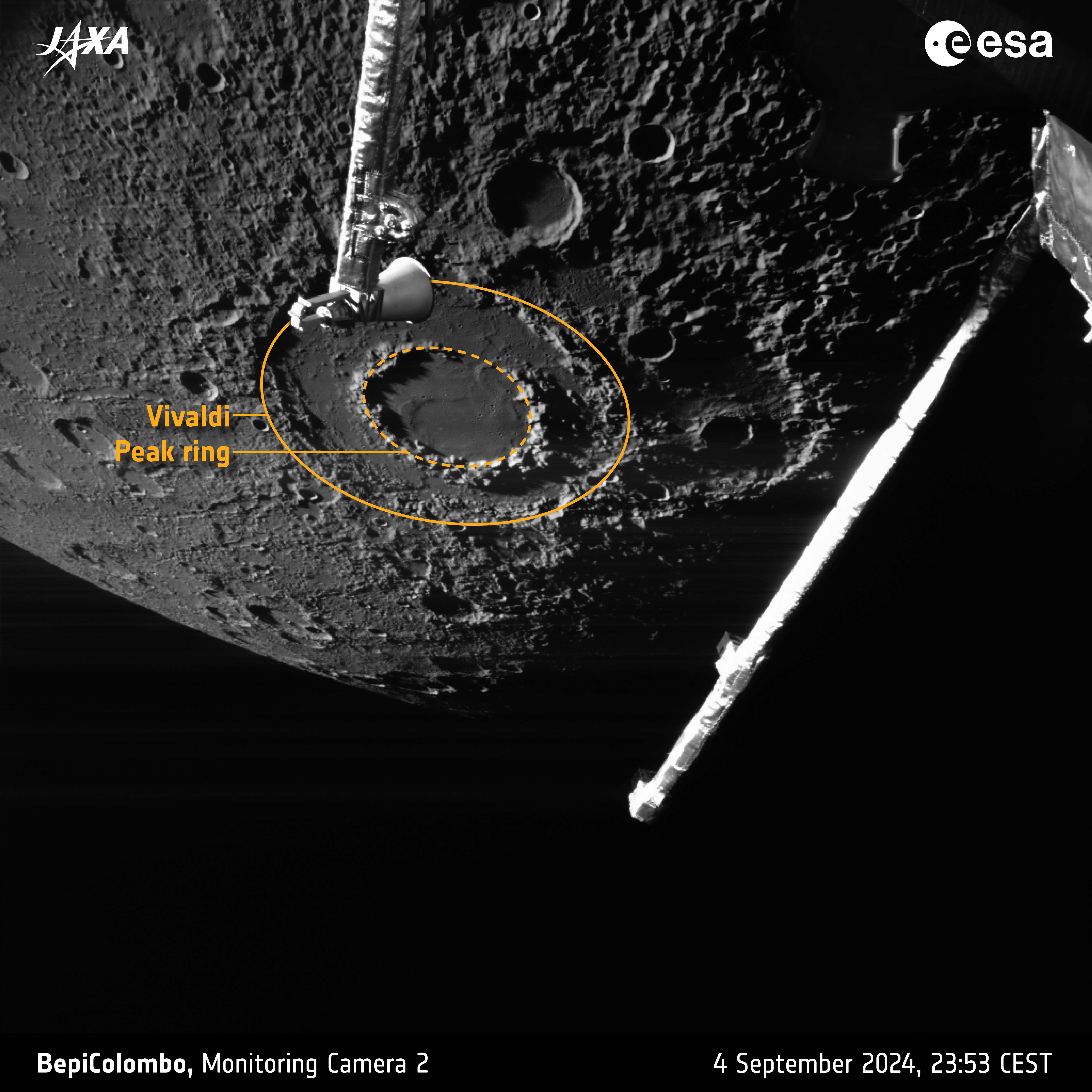 Planet Mercury in the background with its grey, cratered, pock-marked surface. In the foreground are some spacecraft parts. The main focus is a crater with a double rim looking like a flat donut.