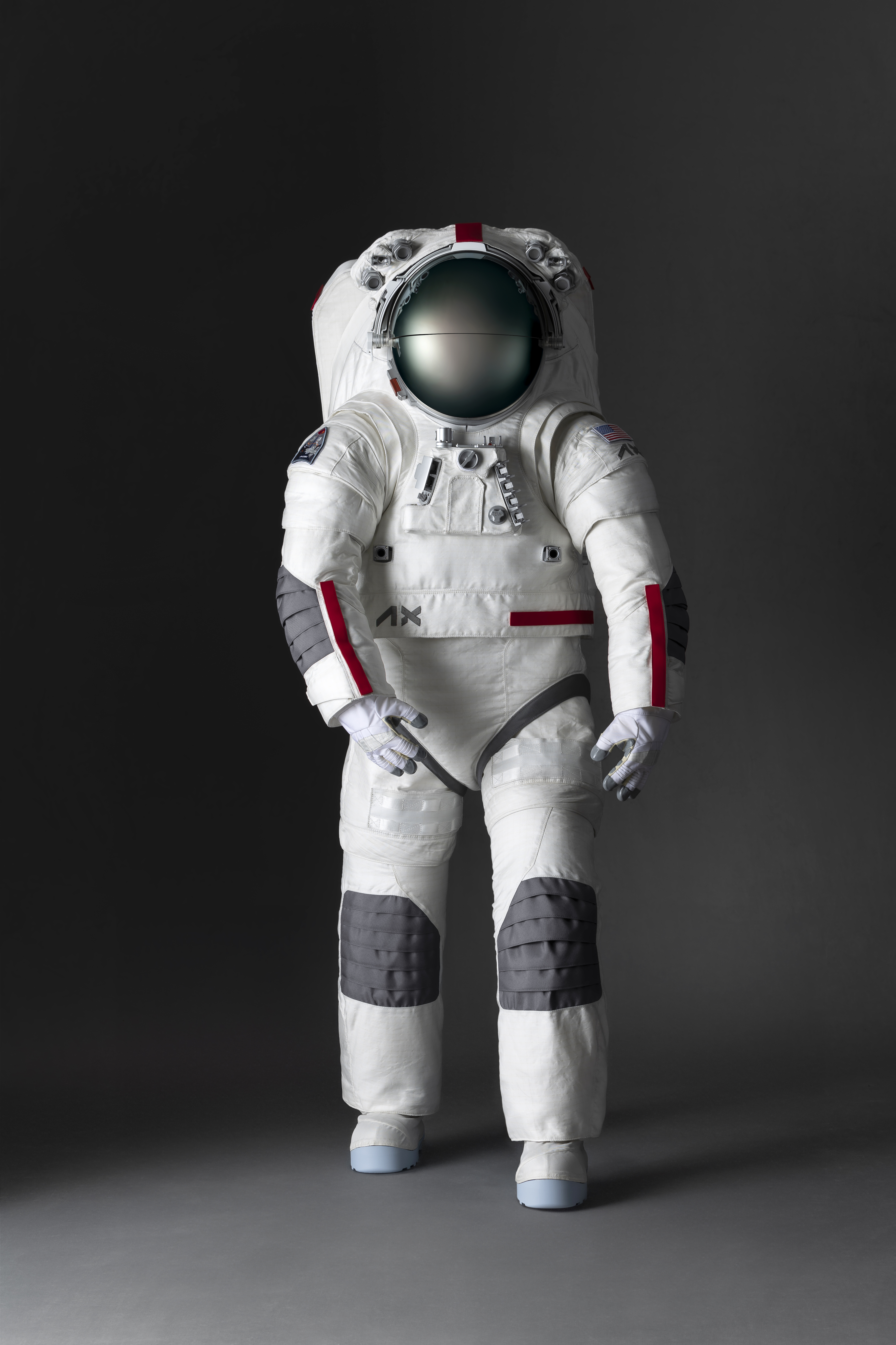 The spacesuit is mostly white with grey ridge structure at the hount for felxibility. the sunviors is pull down and look an opaque grey. it has some red accents on the forearms side and top.