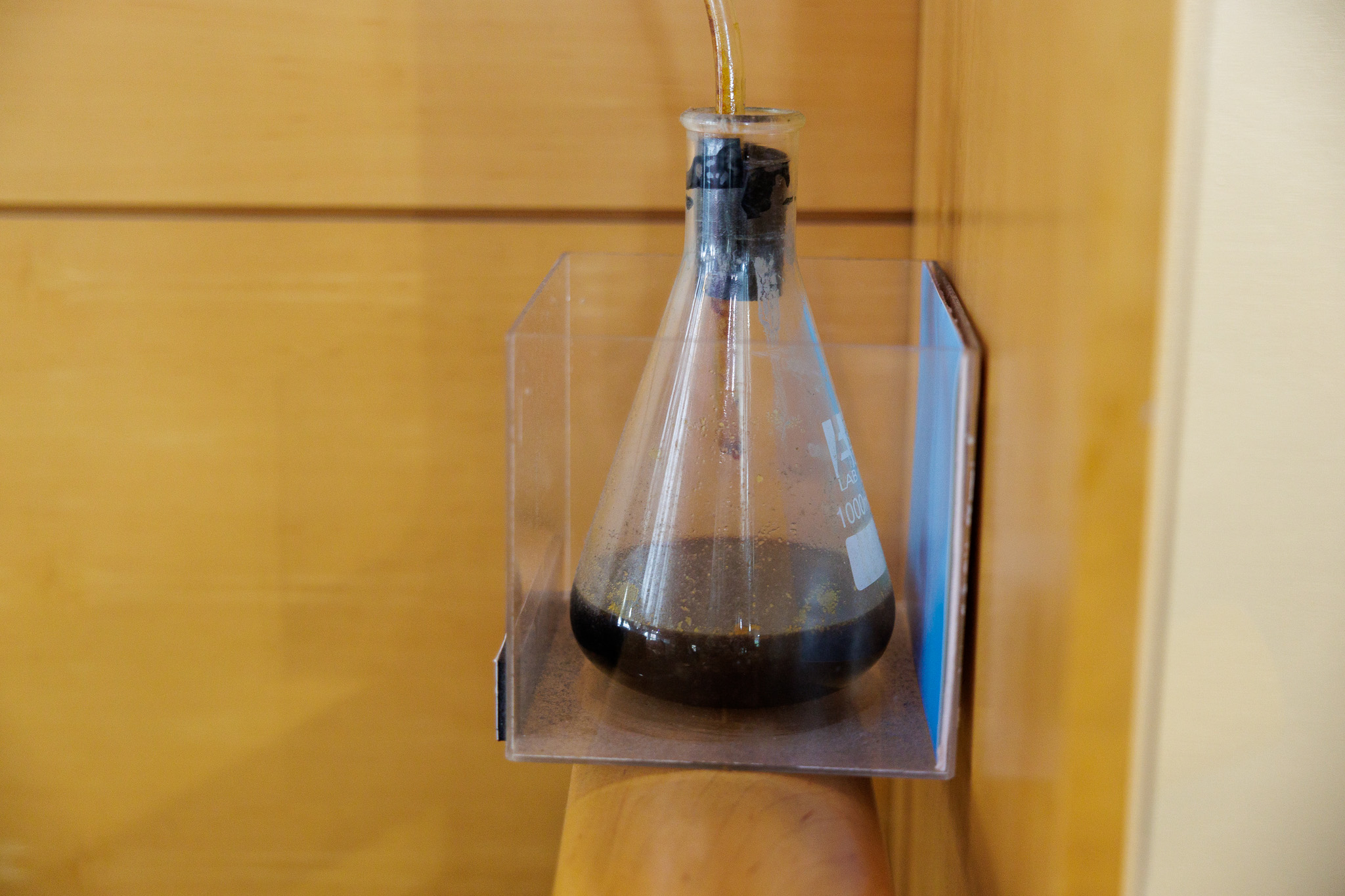 glass flask containing a dark oil