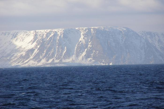 While tracking the capelin the researchers photographed the snow-capped cliffs of Norway nearby.