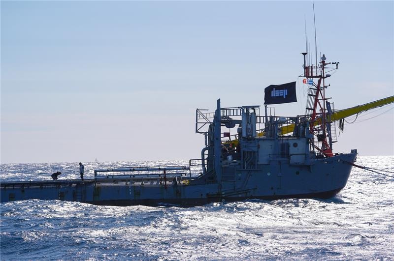 R/P FLIP on the ocean, viewed slightly closer with the new flag flying, showing the pale blue 