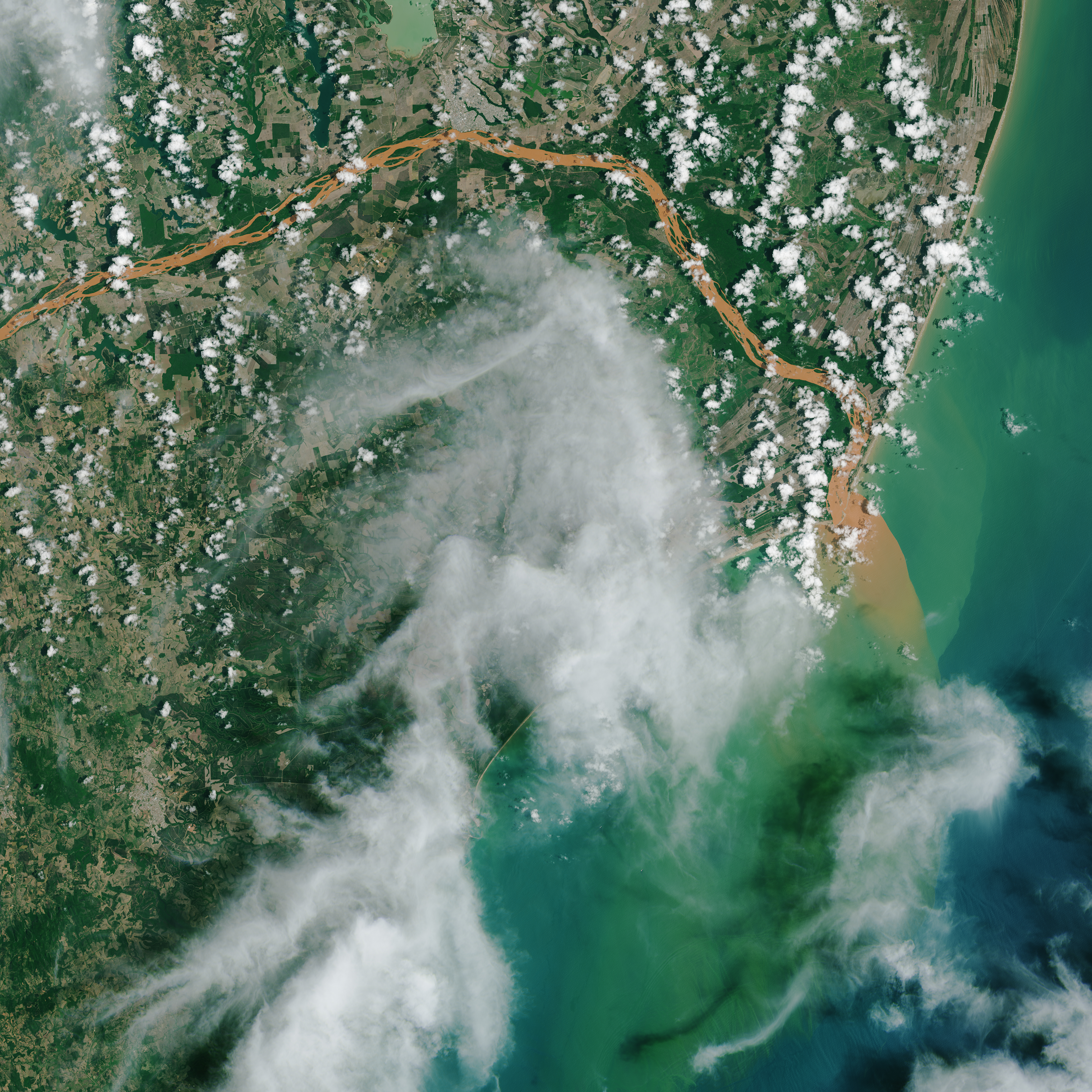 satellite image of the contaminated Doce River flowing into the Atlantic Ocean in 2015