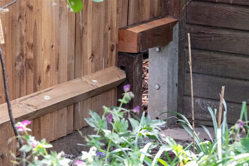 a small gap in a garden fence made specially for wildlife to pass through