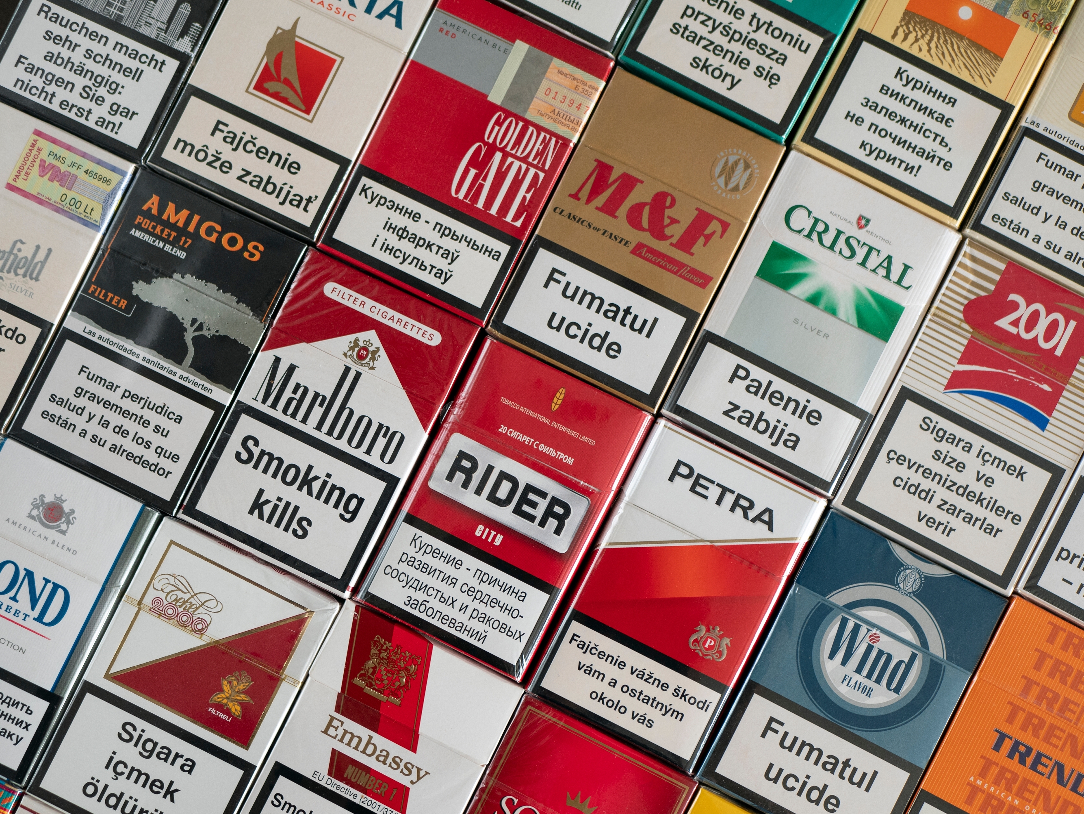 cigarette packets with warning labels in many different languages