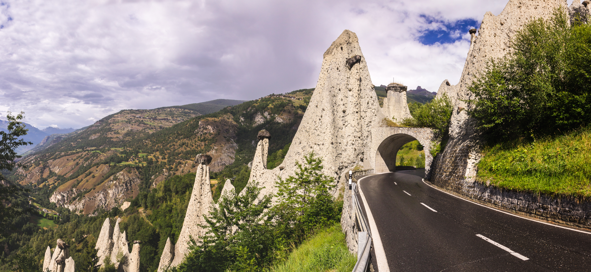 A road in the Alps cutting through the Pyramids of Euseigne.