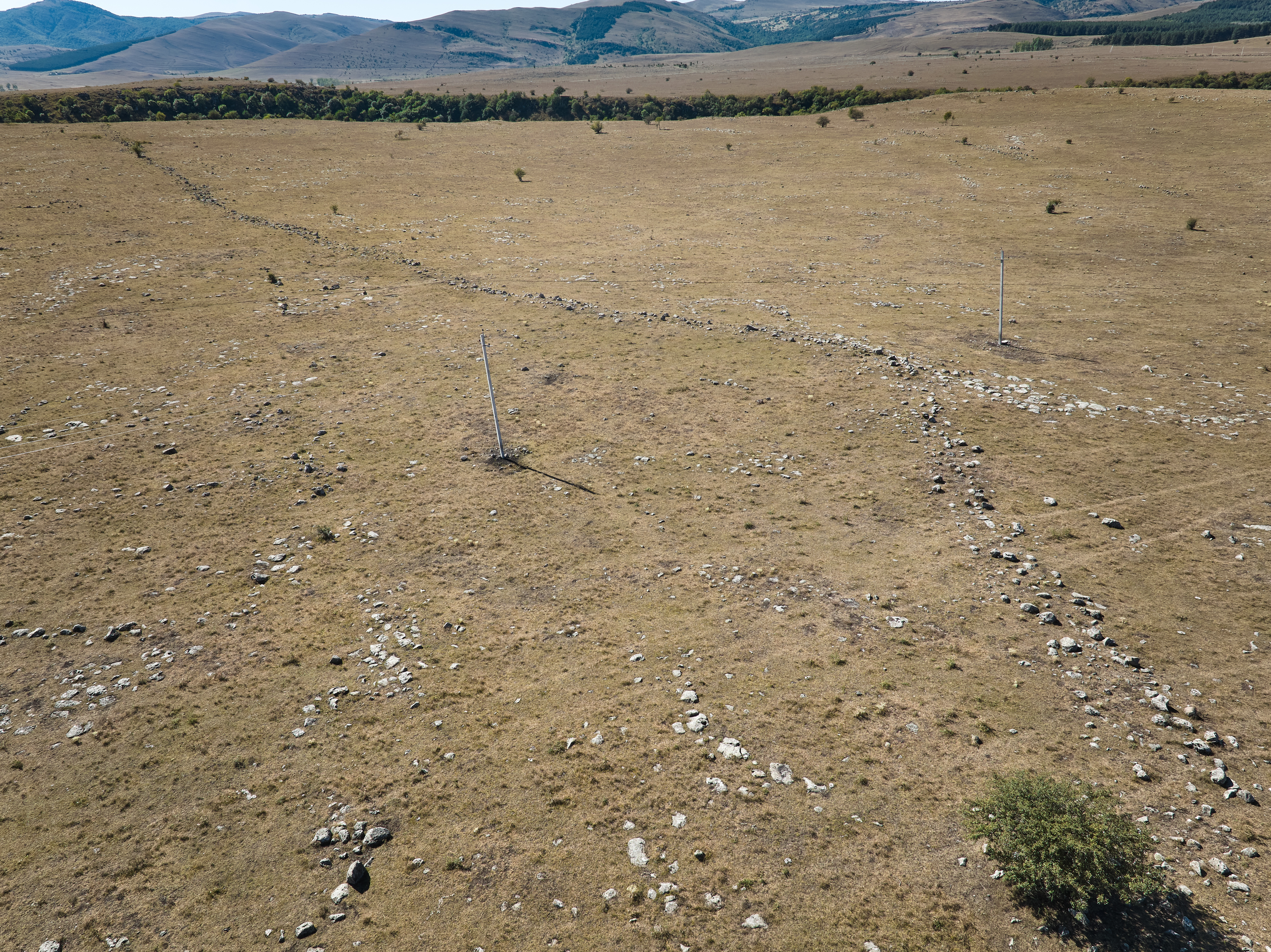 Photo of 1 km long outer fortification wall. Power/telephone line poles for scale.