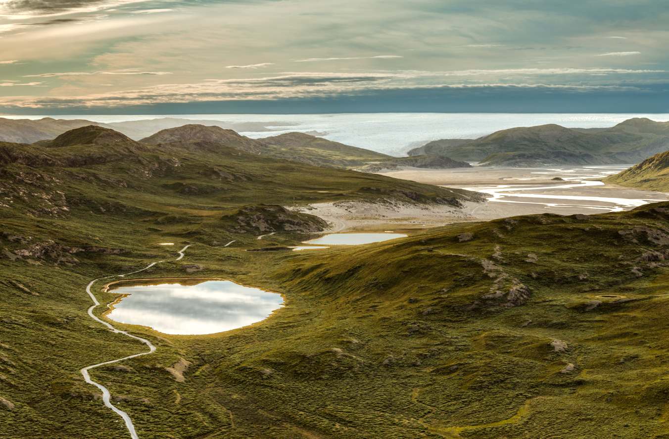 Lakes and rolling green hills in Greenland, along with beautiful sunset.