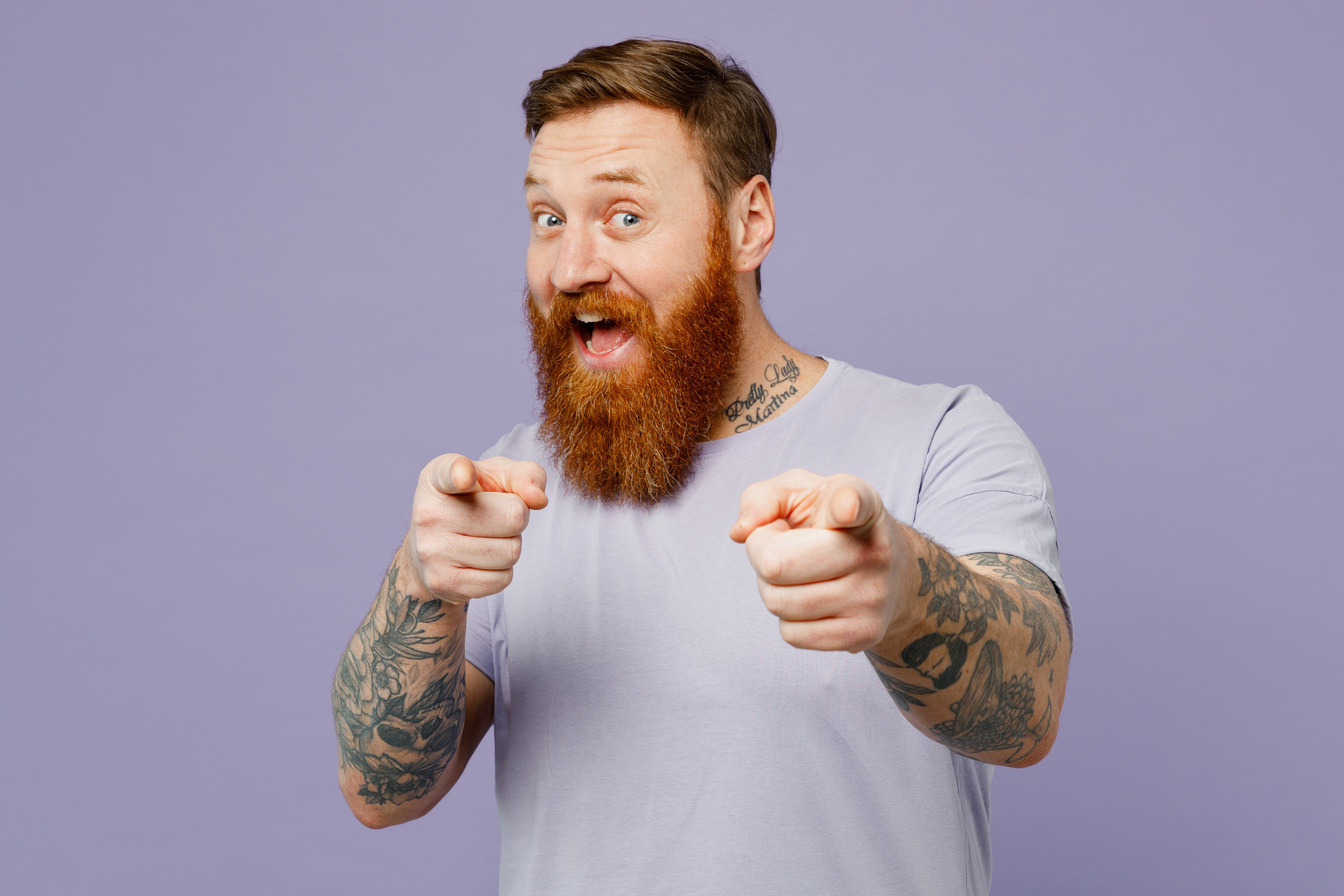 Red-headed man with beard pointing at the camera