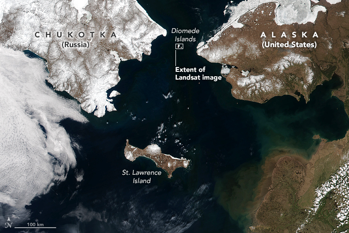 satellite image of the bering strait, with st lawrence island, and the diomede islands highlighted