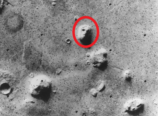 a red ring around the rocky formation on mars that looks like a face with eyes nose and mouth