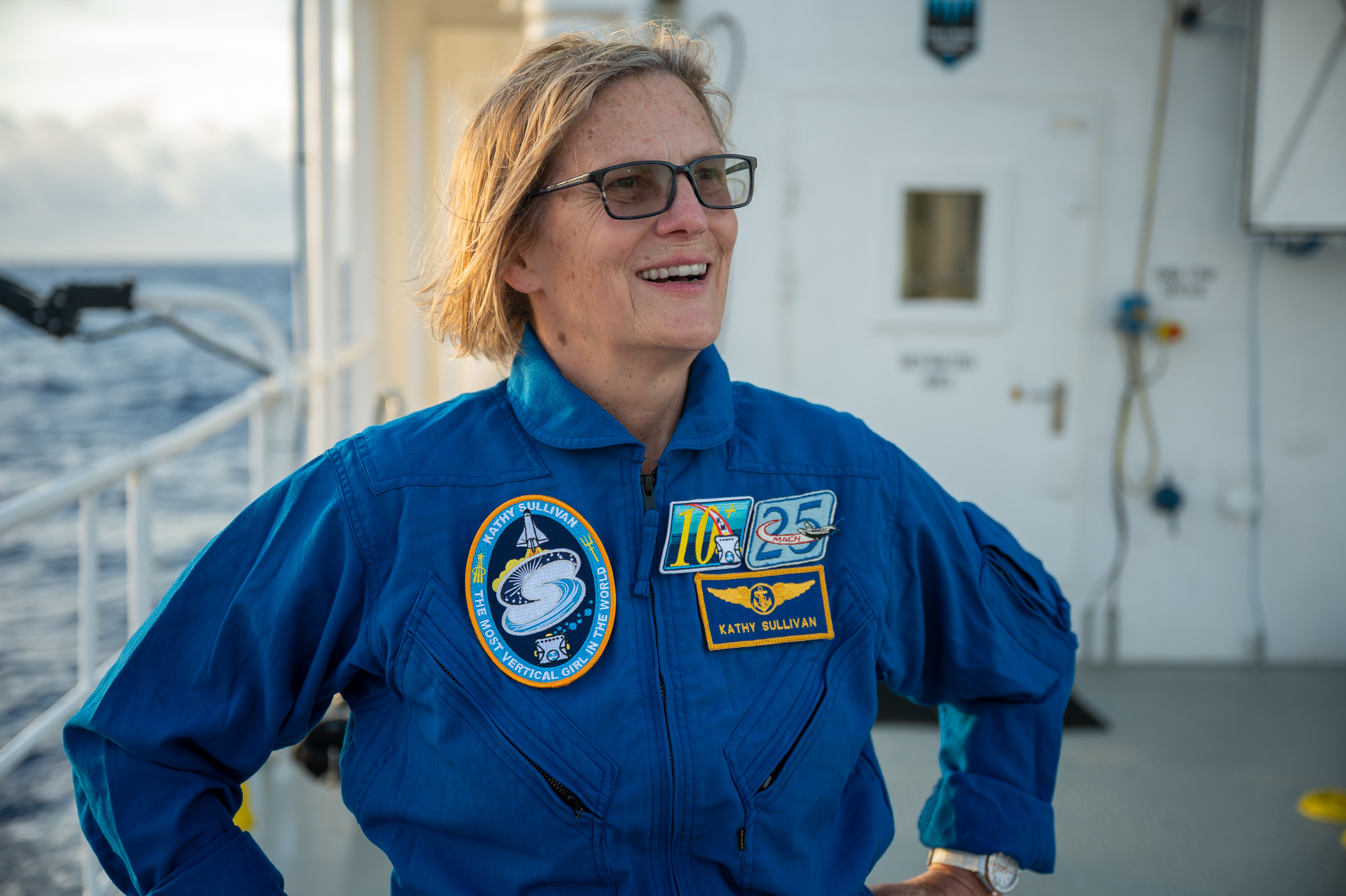 A photo of Dr Sullivan smiling. A patch on her jacket says earning the title of The Most Vertical Girl In The World