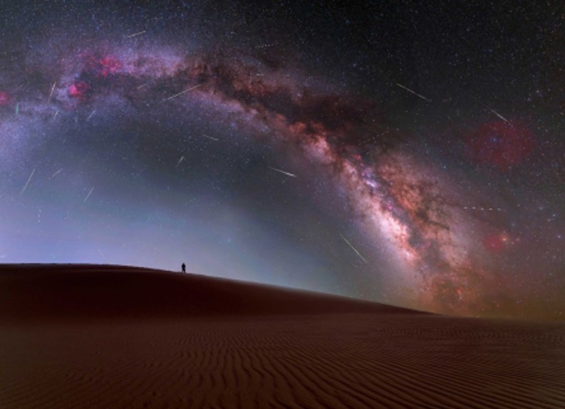 The Milky Way arching over a desert landscape. The Milky Way arching over a desert landscape.