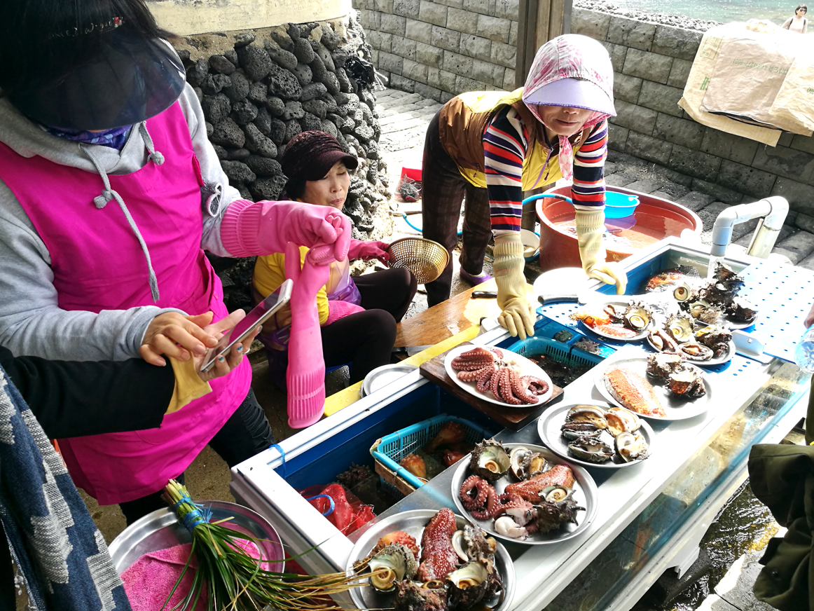 A group of Haenyeo women selling fresh seafood on Jeju Island, South Korea. A group of Haenyeo women selling fresh seafood on Jeju Island, South Korea.