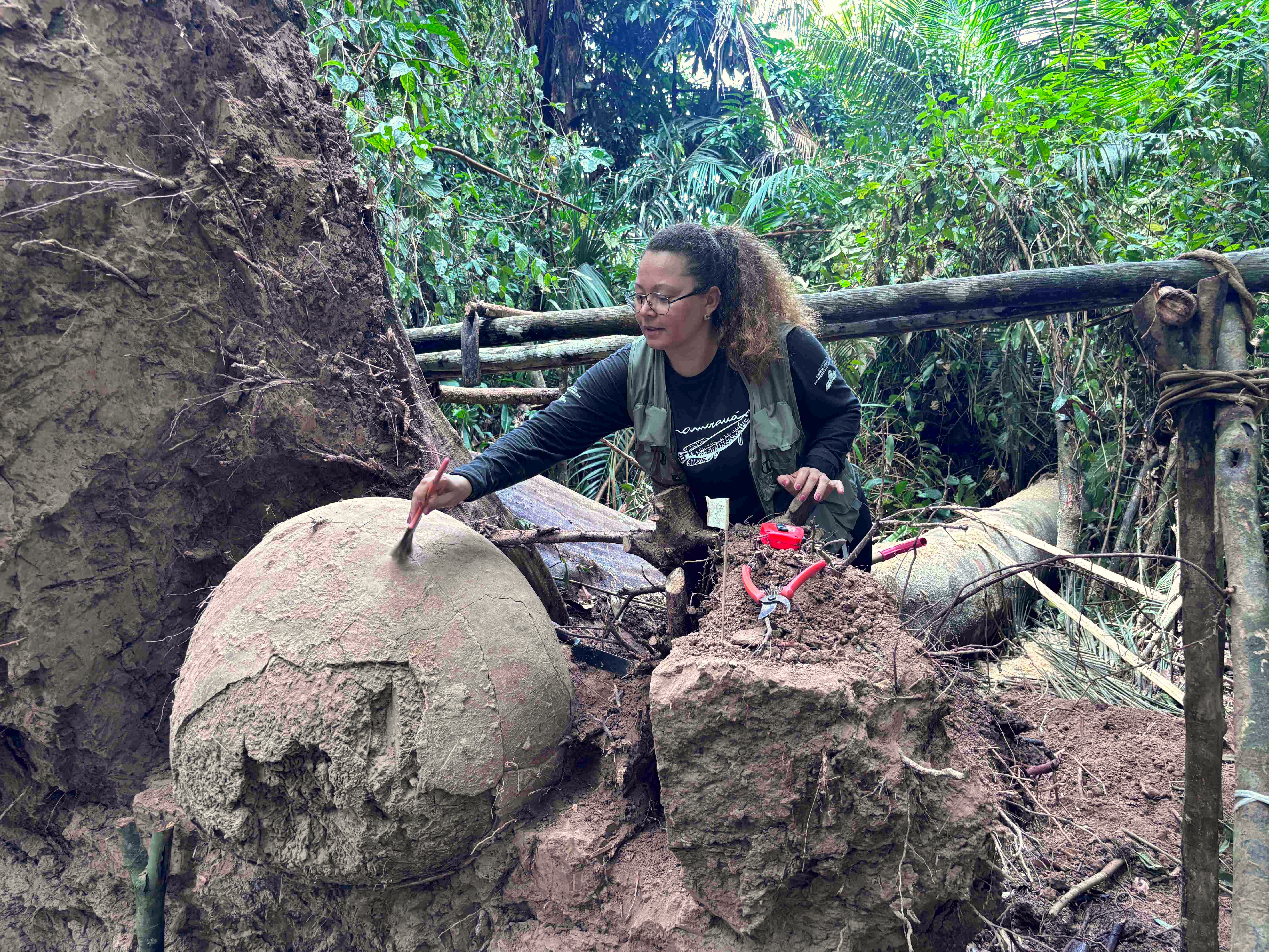 An archaeologist with an ancient Amazonian funerary urn An archaeologist with an ancient Amazonian funerary urn