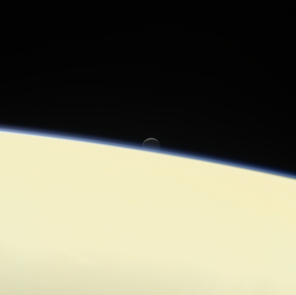 Enceladus setting behind Saturn. Enceladus setting behind Saturn.