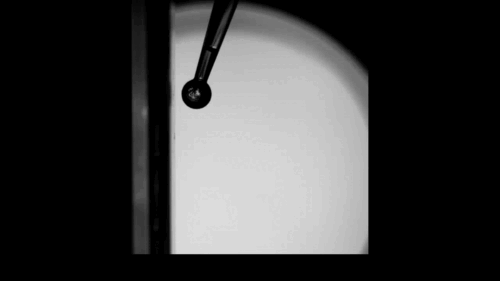 A ball rolls vertically down a surface. A ball rolls vertically down a surface.