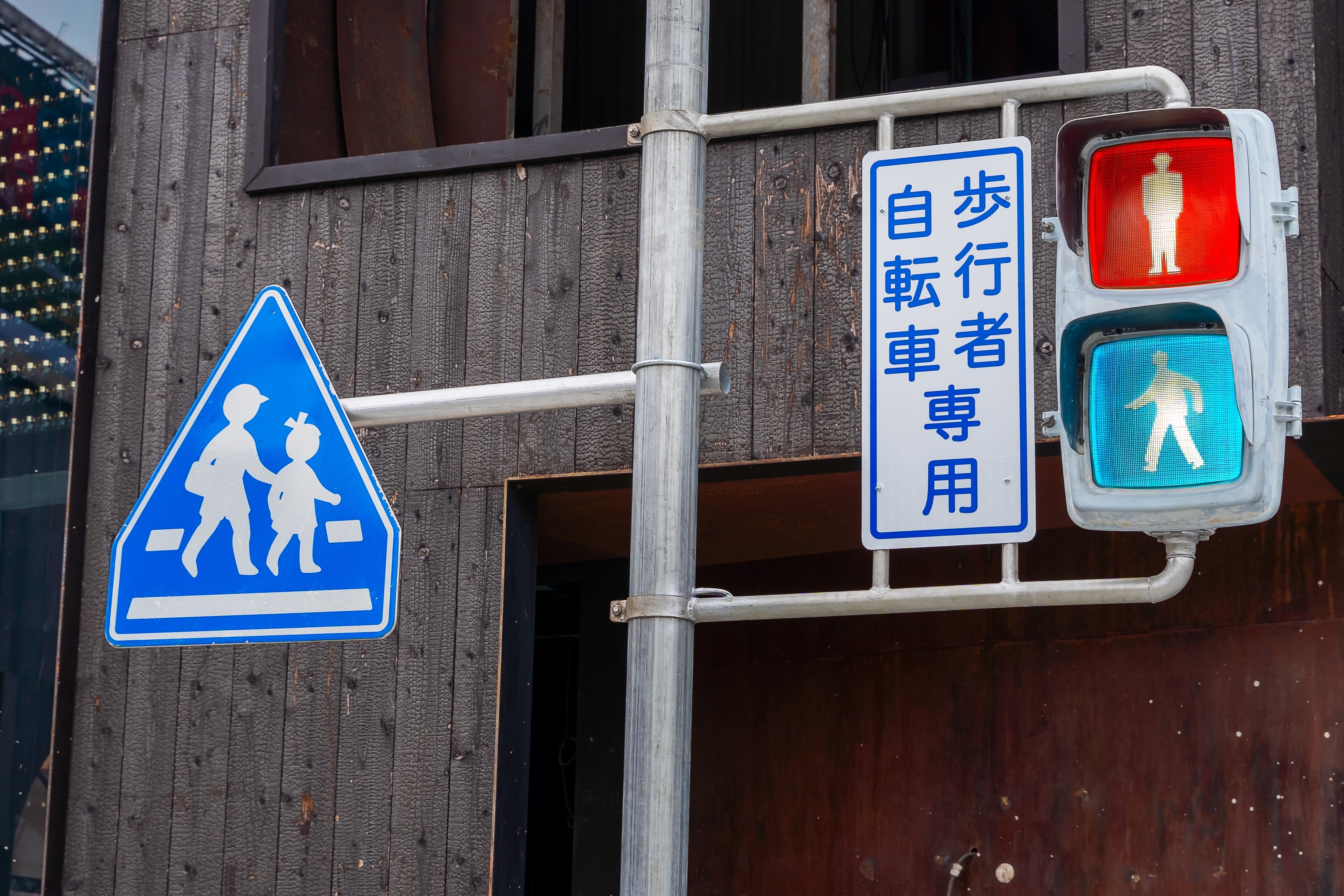 A blue traffic light in Japan at a pedestrian crossing. A blue traffic light in Japan at a pedestrian crossing.